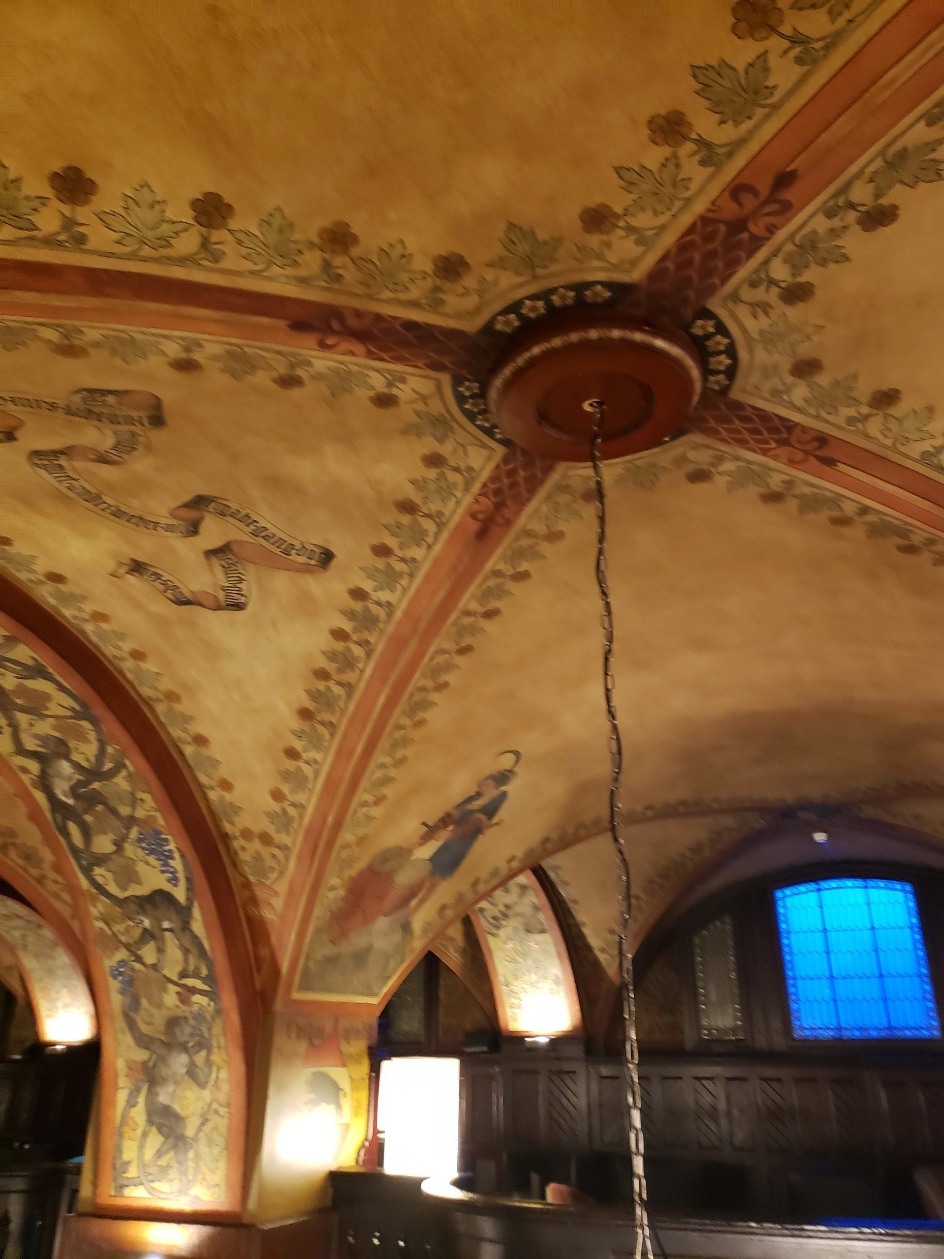A ceiling with arches and paintings on it