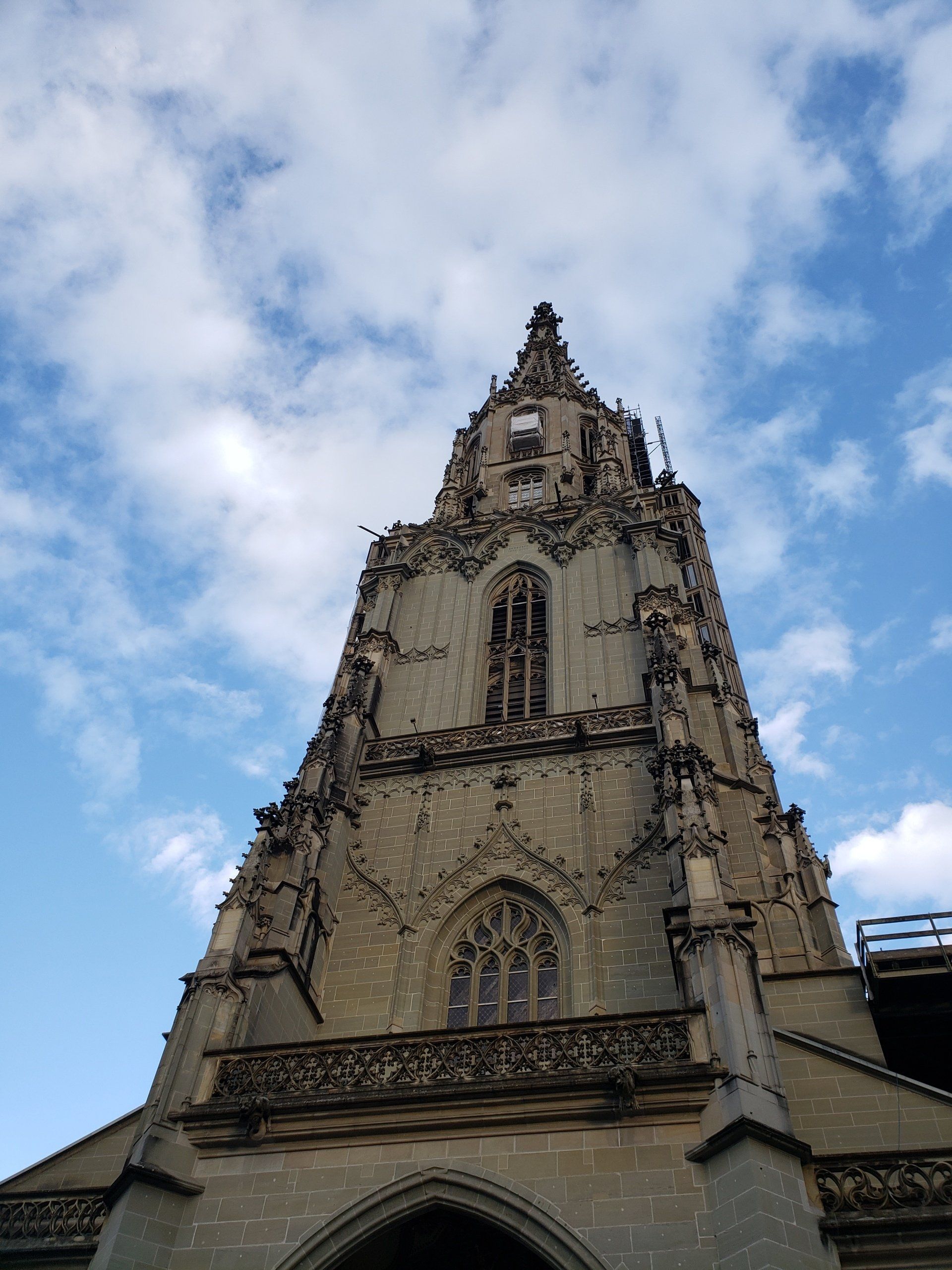 Looking up at a very tall building with a blue sky in the background
