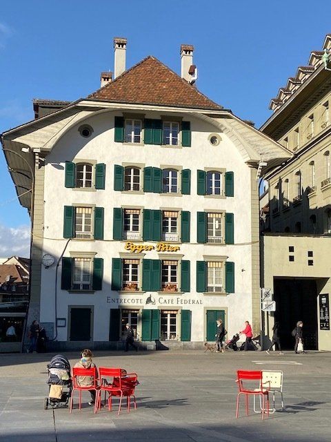 A large white building with green shutters and a sign that says ' eggershof ' on it