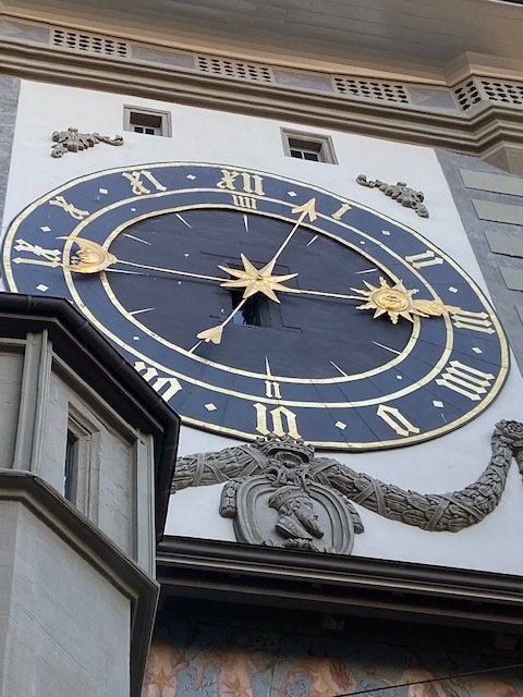 A large clock on the side of a building with roman numerals