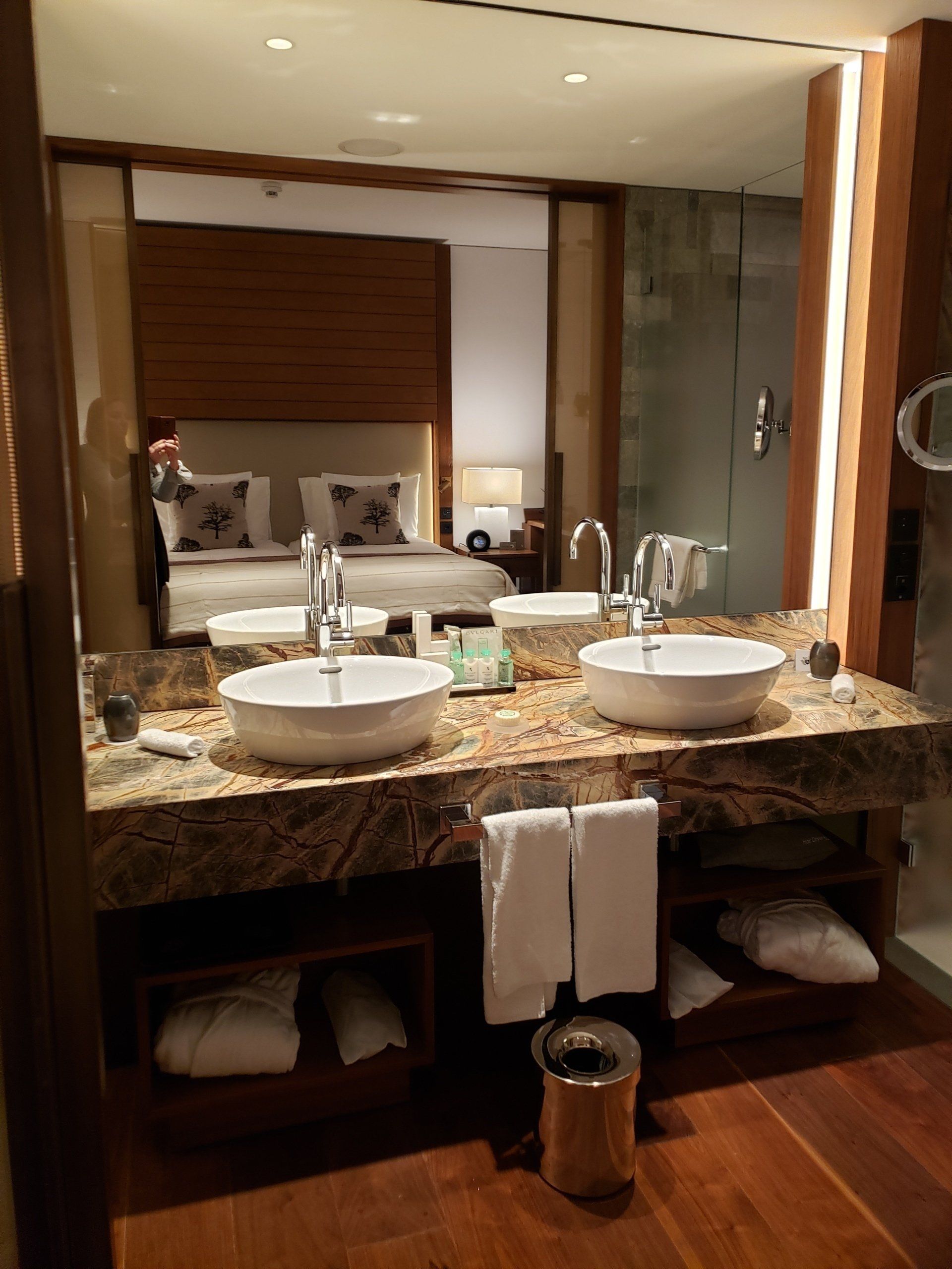 A bathroom with two sinks and a large mirror.