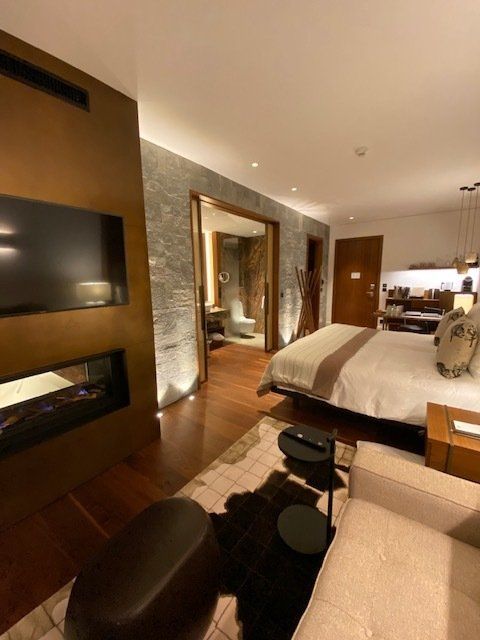 A bedroom with a large bed and a flat screen tv