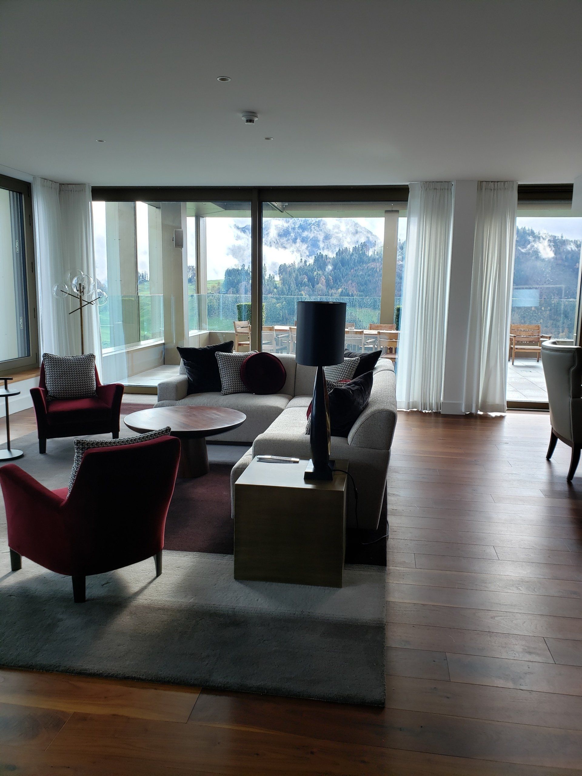 A living room with a lot of furniture and a large window