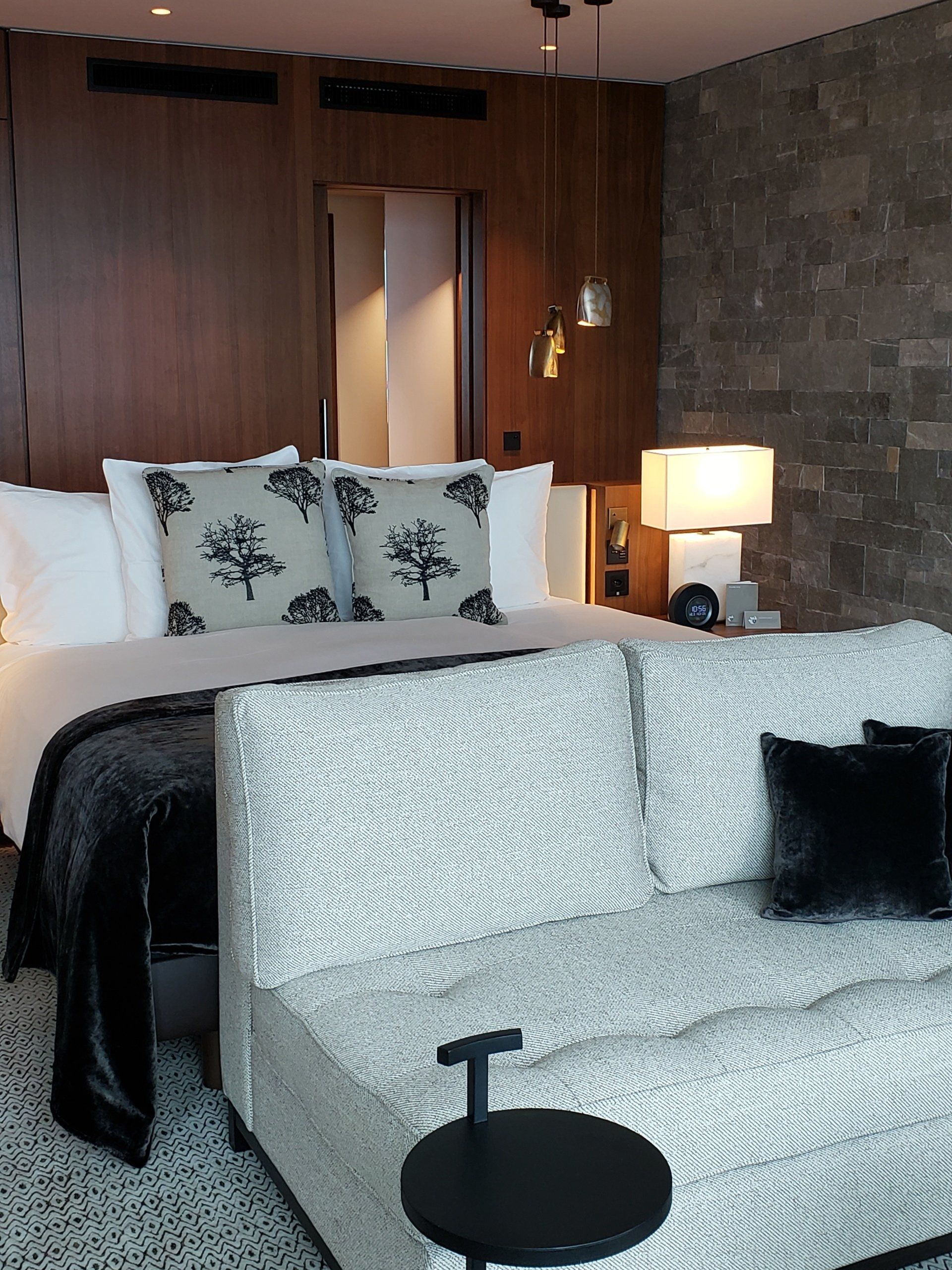 A hotel room with a bed and a couch