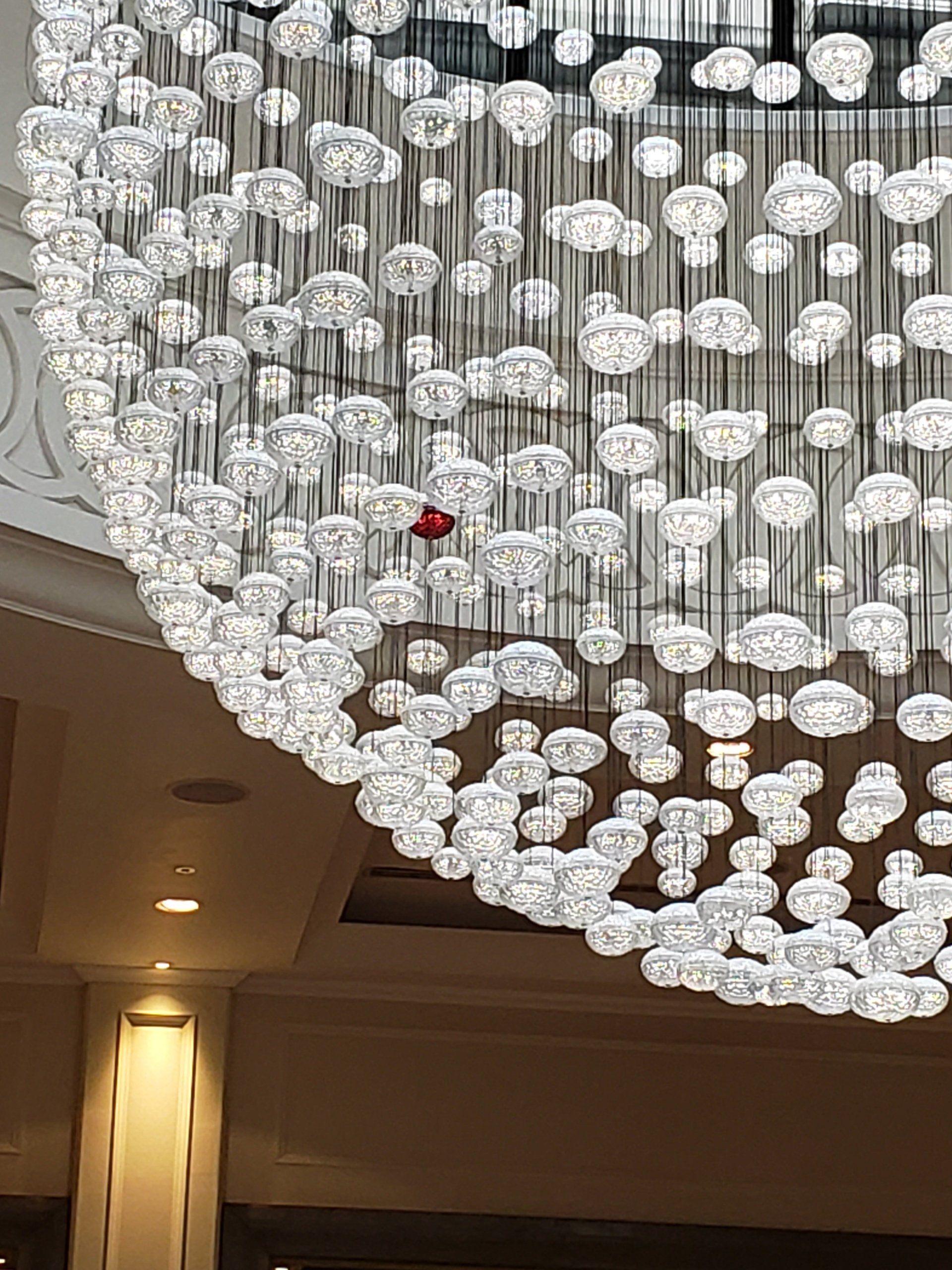 A large chandelier is hanging from the ceiling of a building.