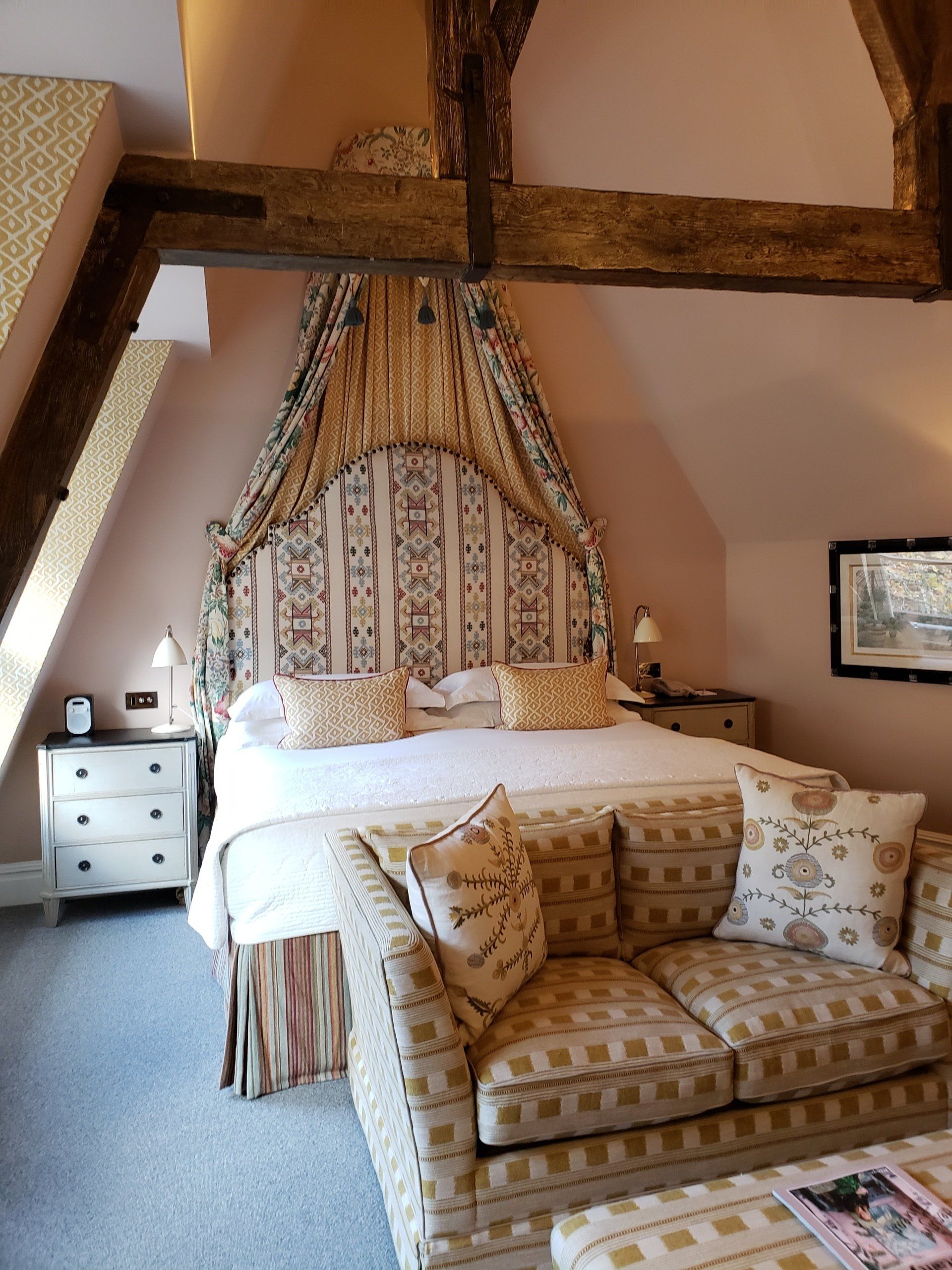 A bedroom with a large bed and a couch