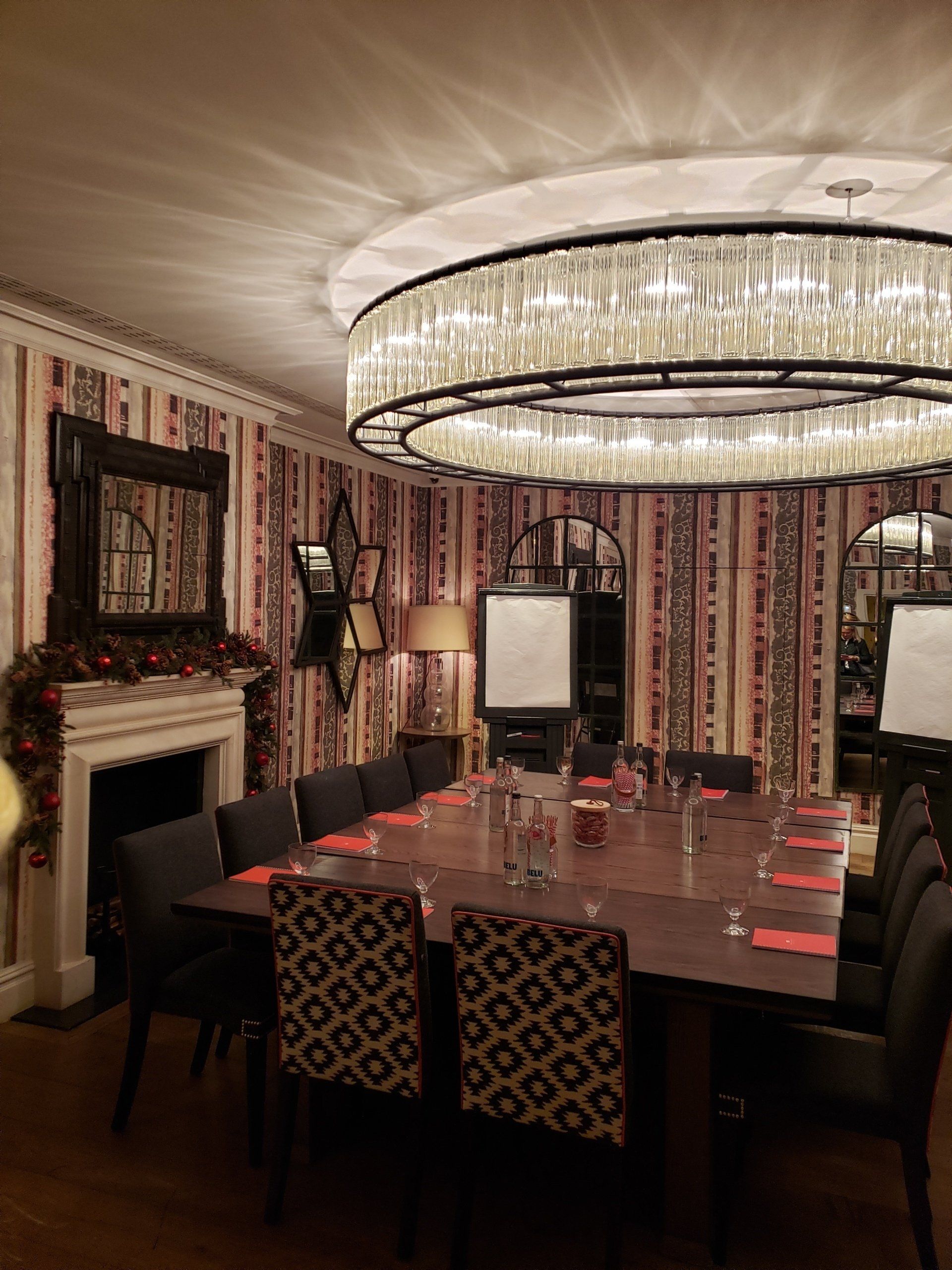 A large room with a table and chairs and a chandelier.