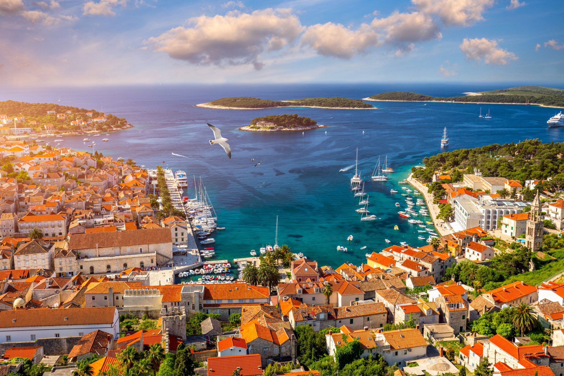 An aerial view of a small town next to the ocean with boats in the water.