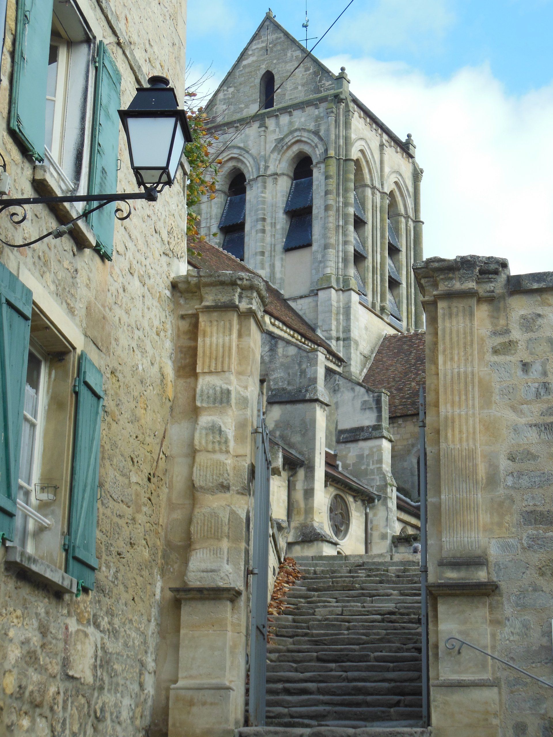 Stairs leading up to a building with a bell tower