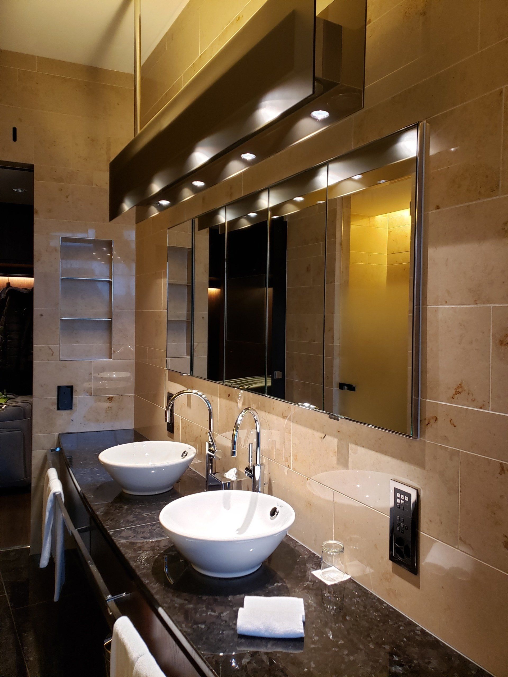 A bathroom with two sinks and a large mirror