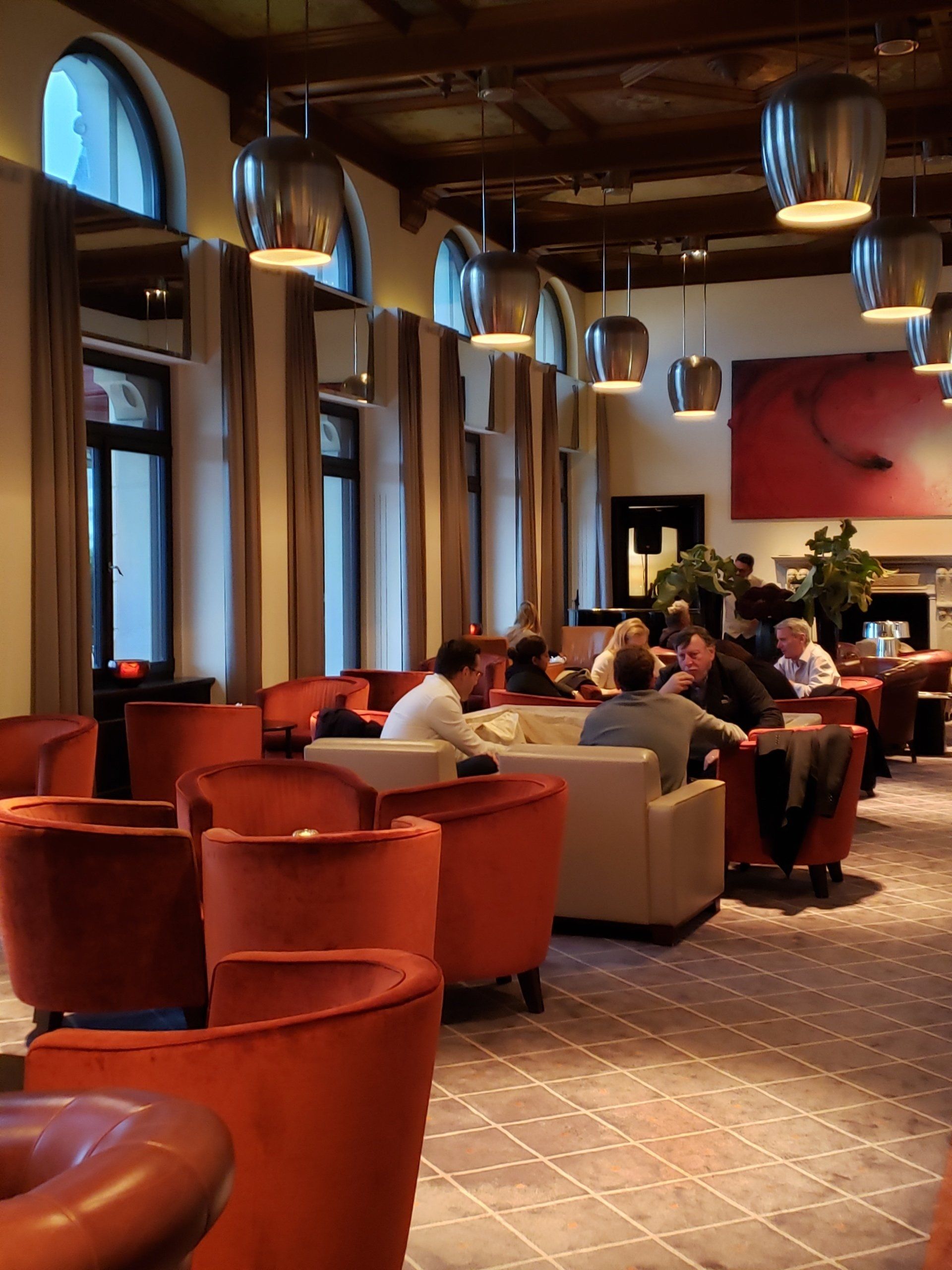 A group of people are sitting at tables in a restaurant