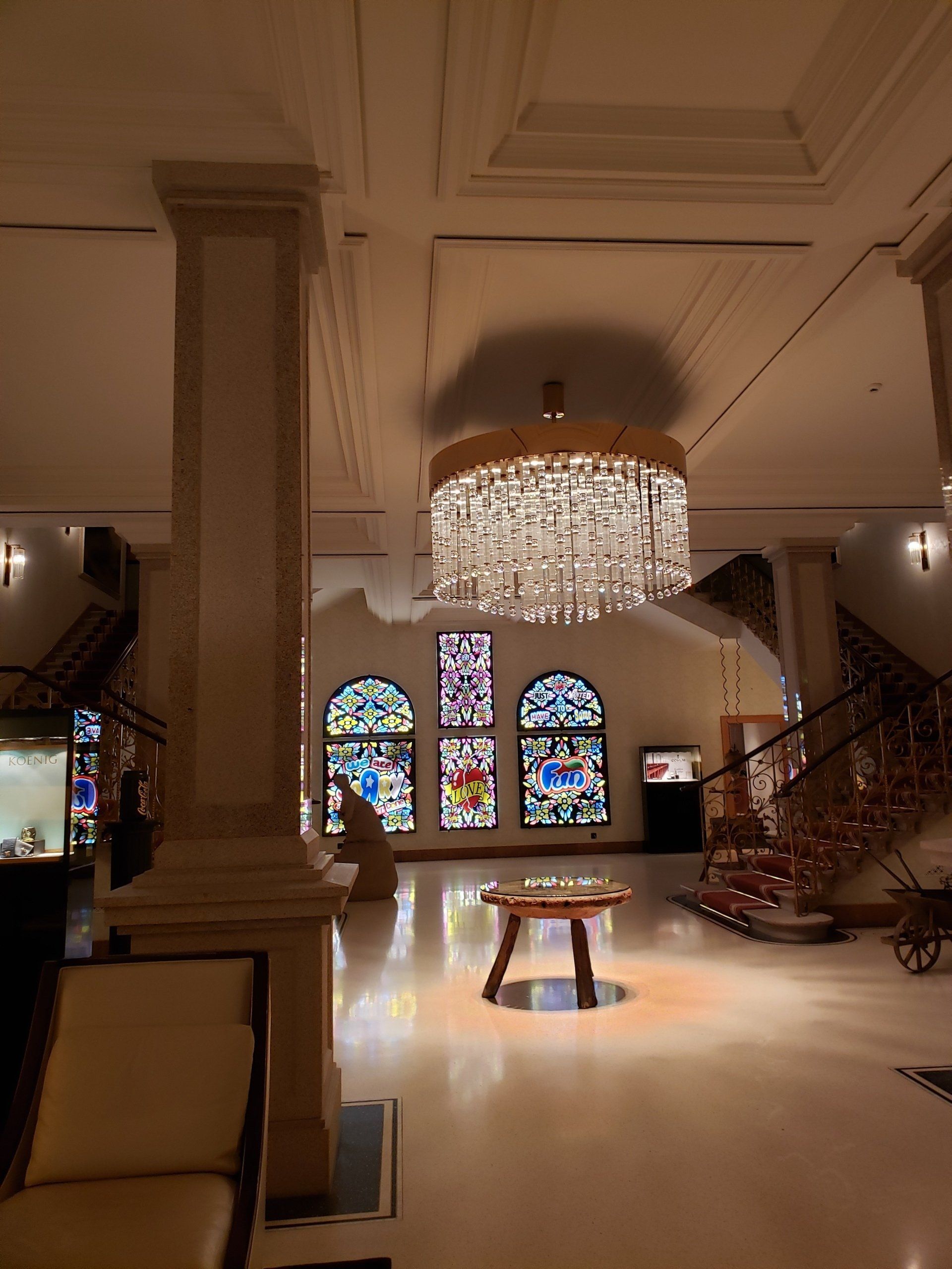 A large room with a chandelier and stained glass windows