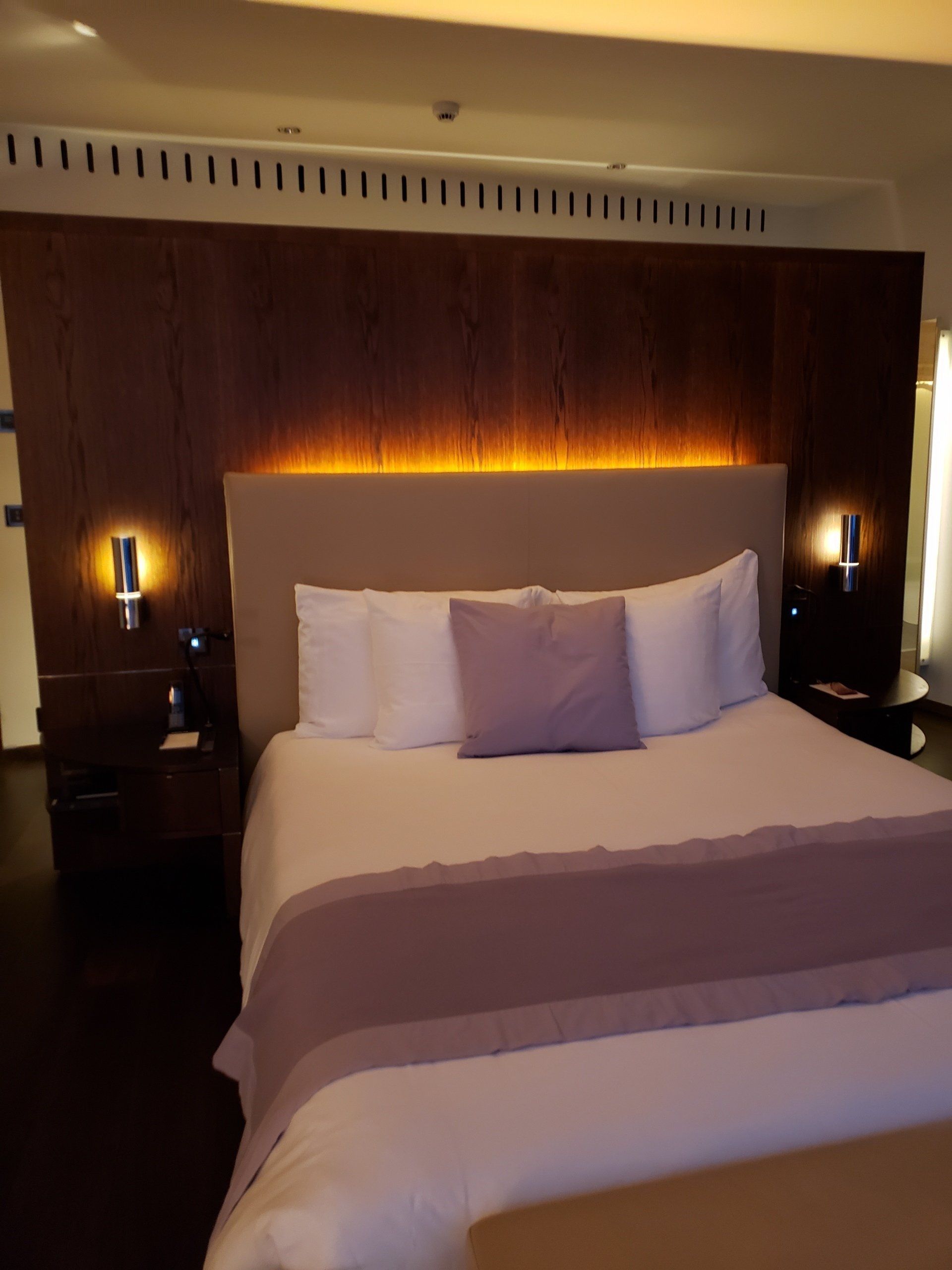 A hotel room with a king size bed and two twin beds