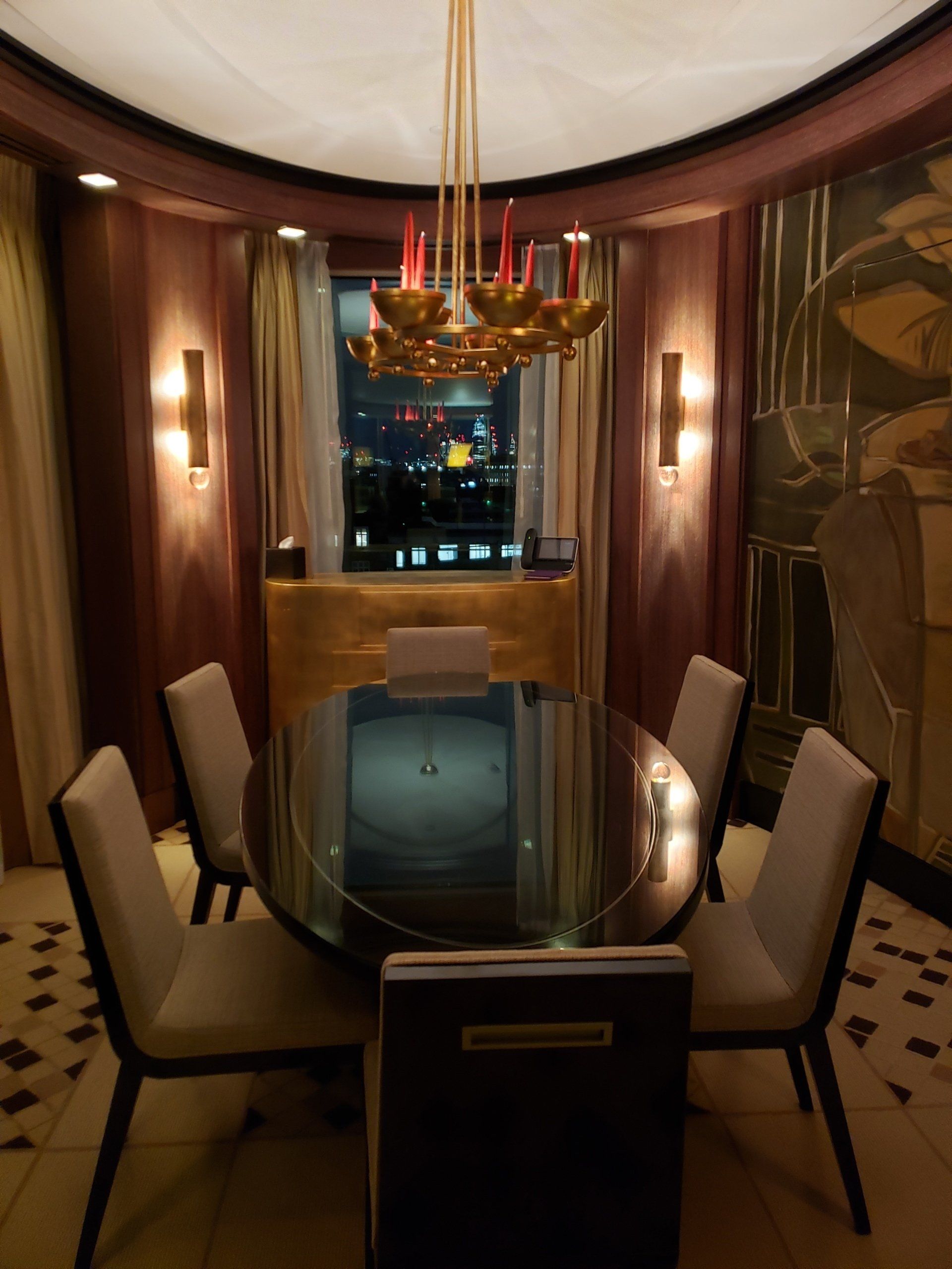 A dining room with a round table and chairs