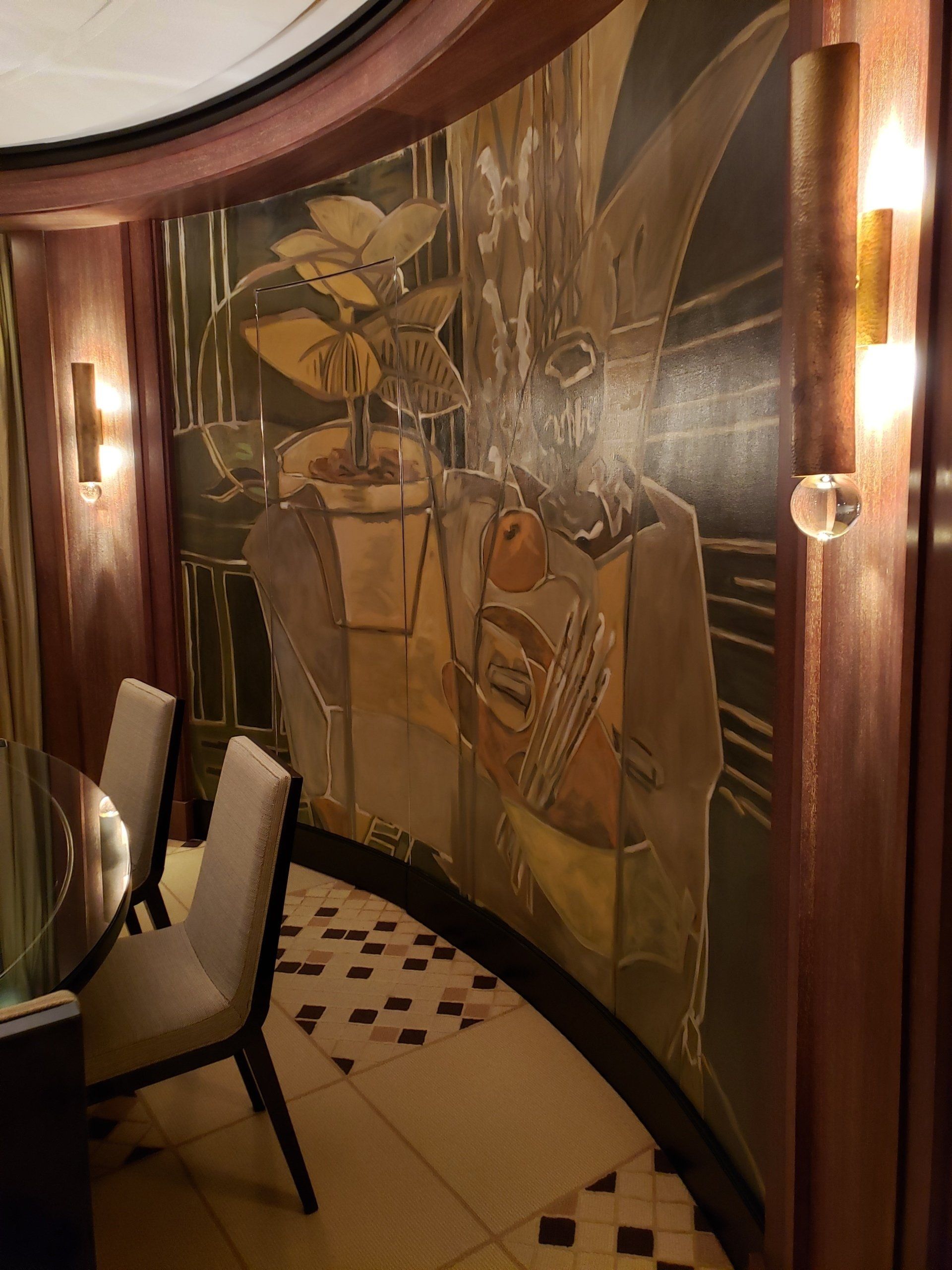 A room with a large painting on the wall