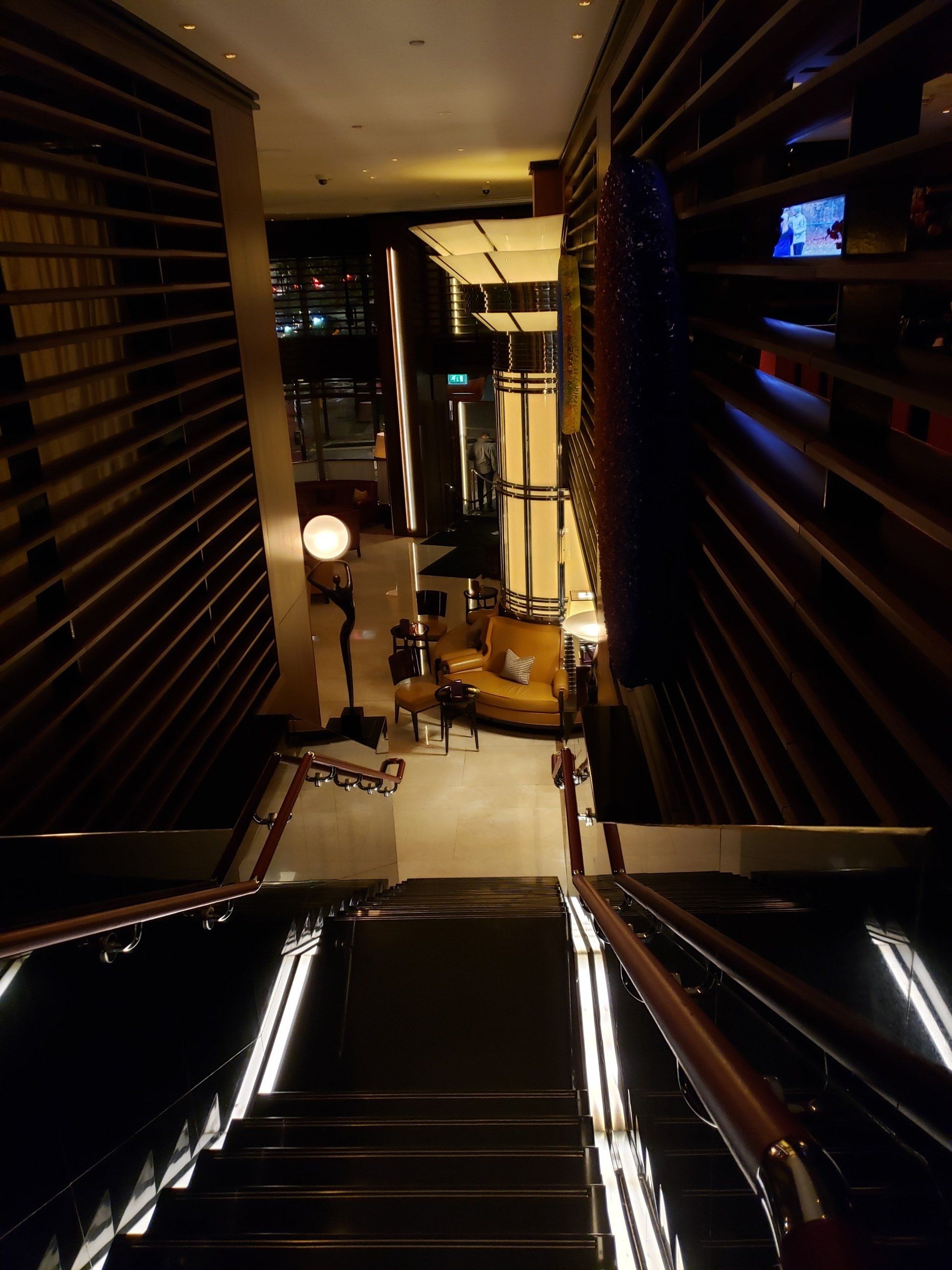 A dark room with stairs leading up to it