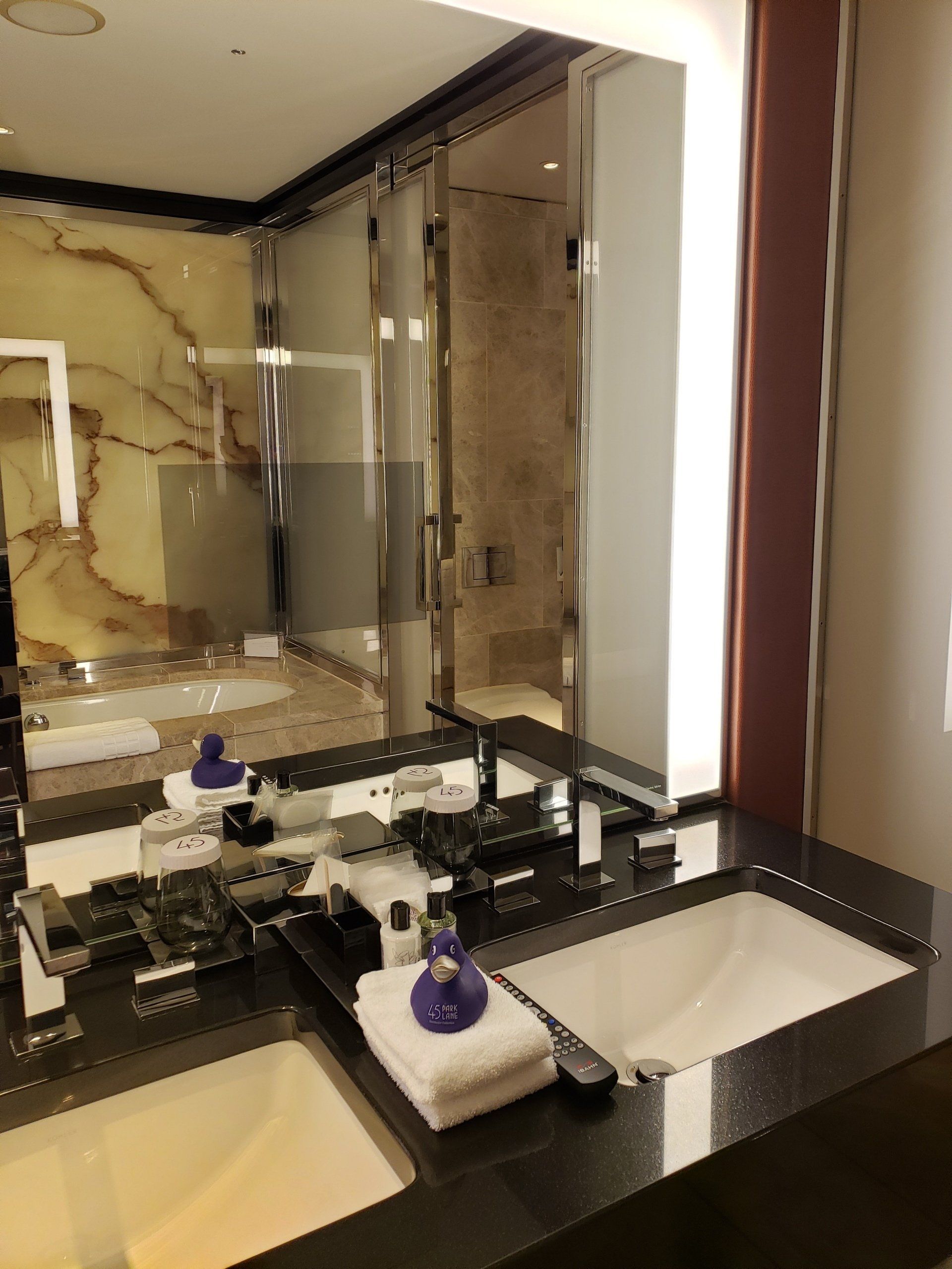 A bathroom with two sinks and a large mirror