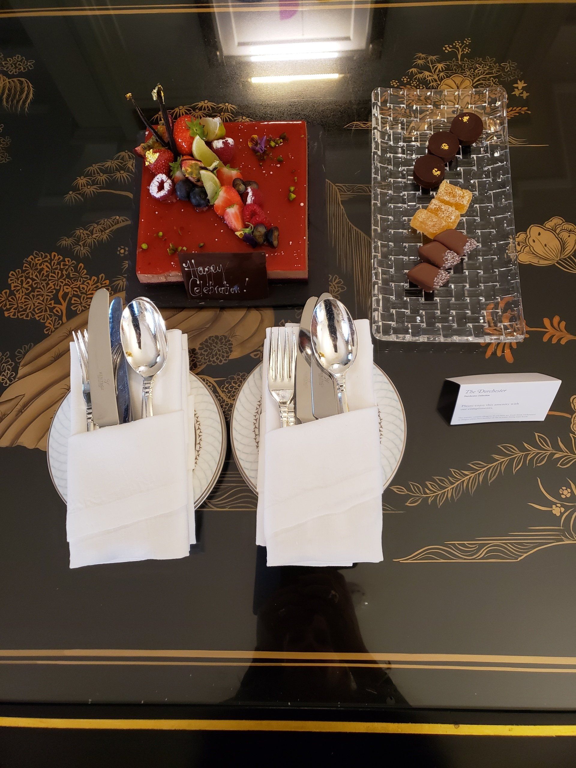 A table with plates of food and utensils on it