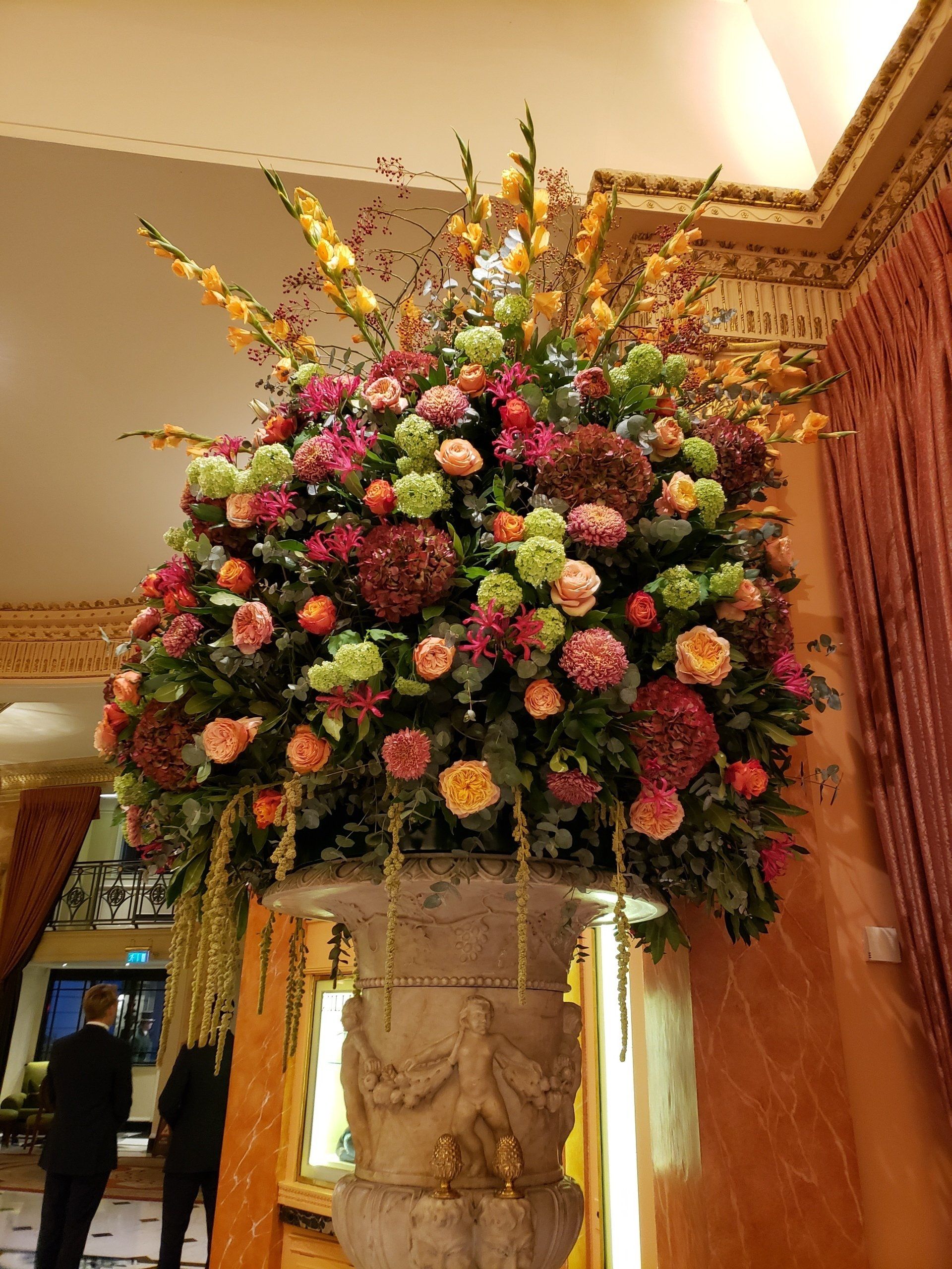 A large vase filled with flowers in a room