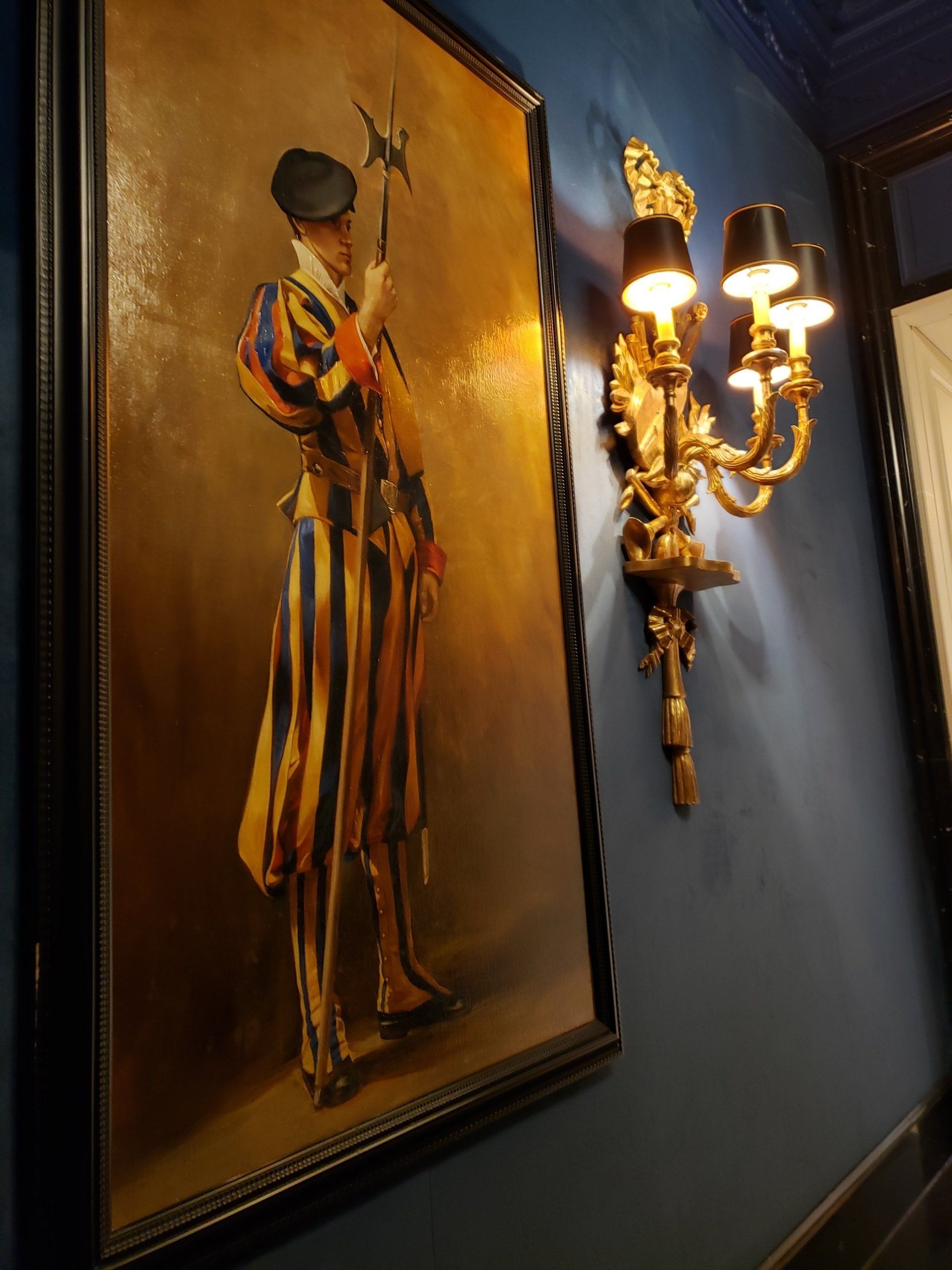 A painting of a man in a striped uniform is hanging on a wall