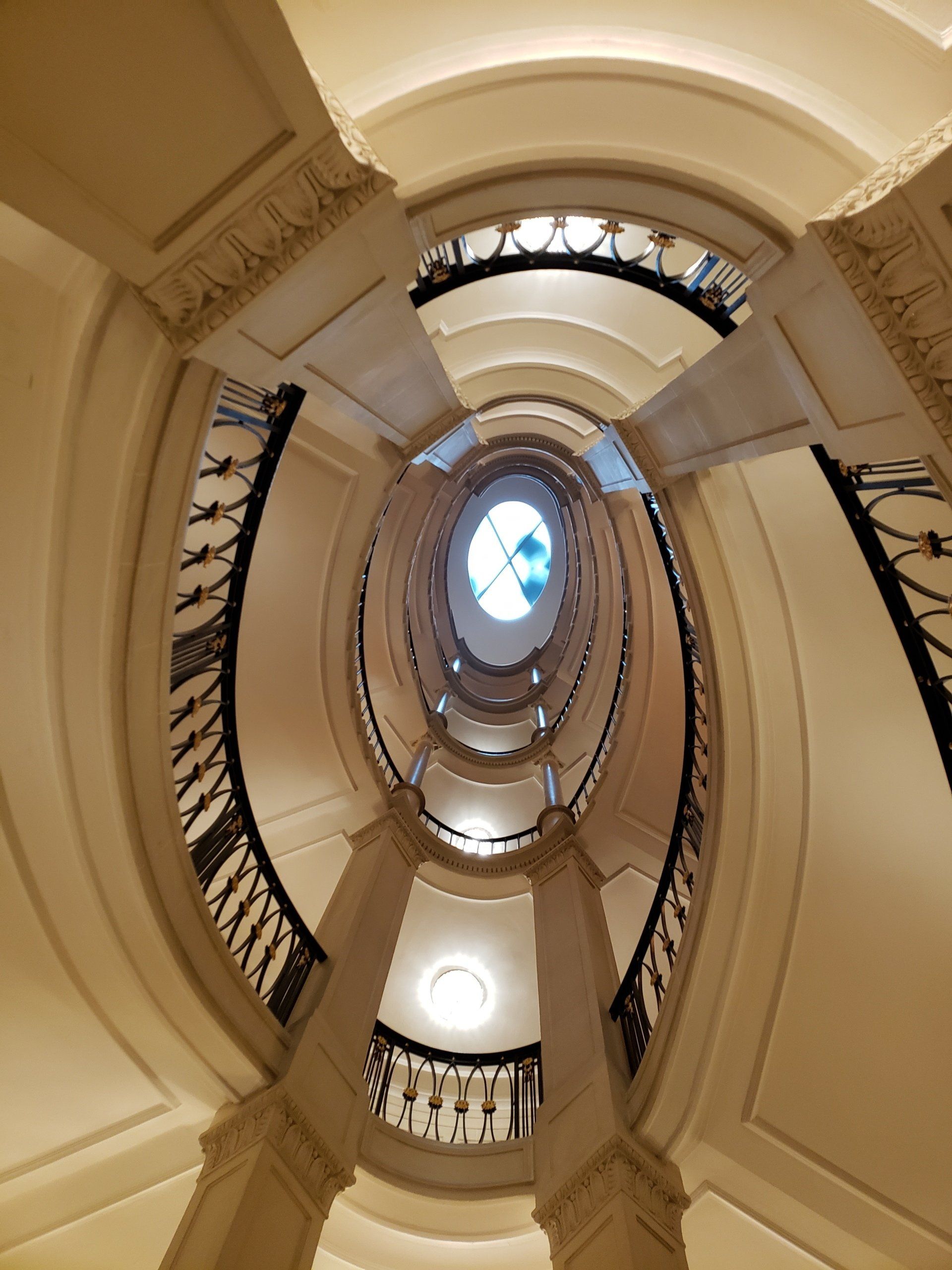 Looking up at a spiral staircase in a building