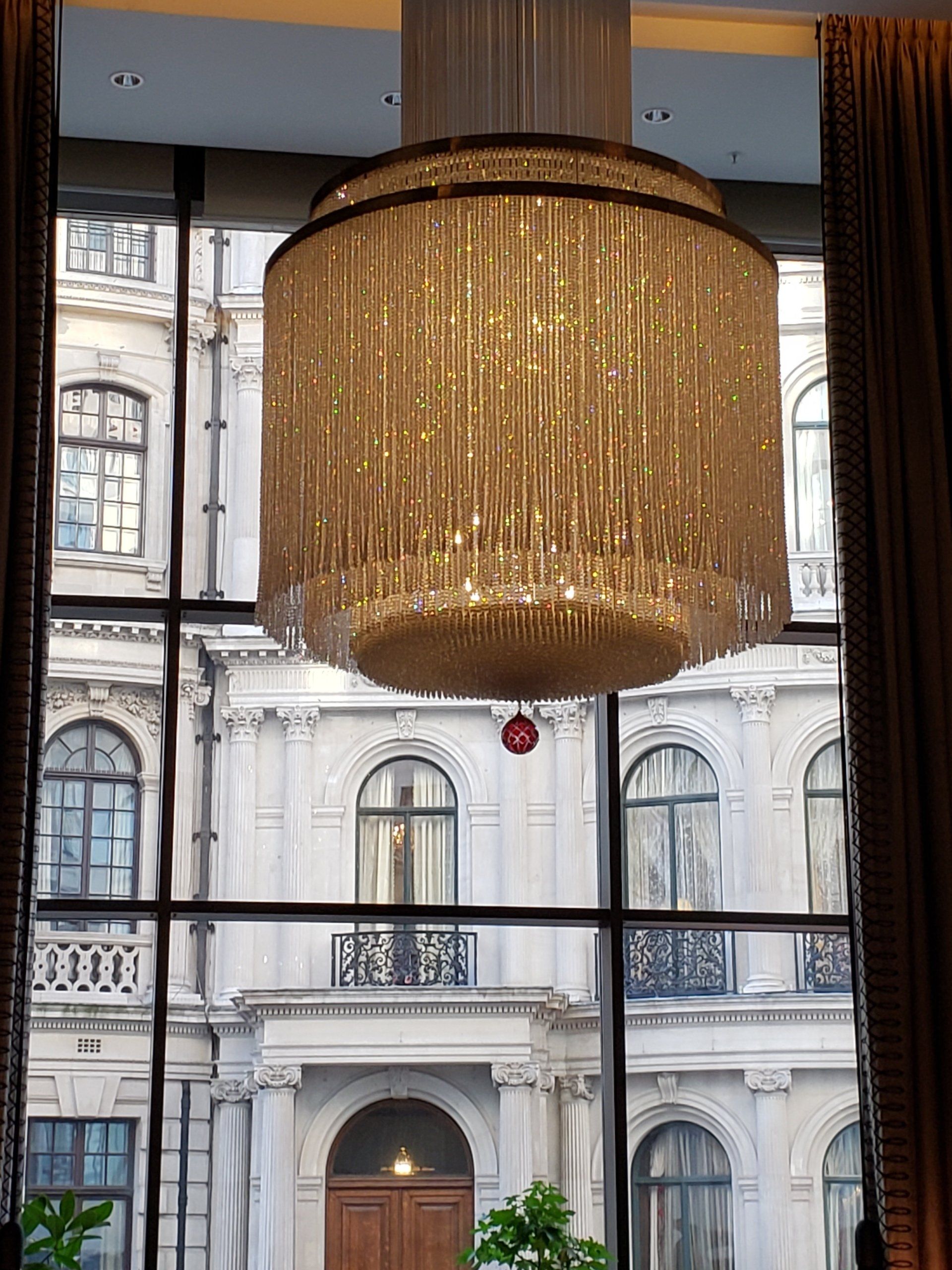 A large chandelier is hanging from the ceiling of a building