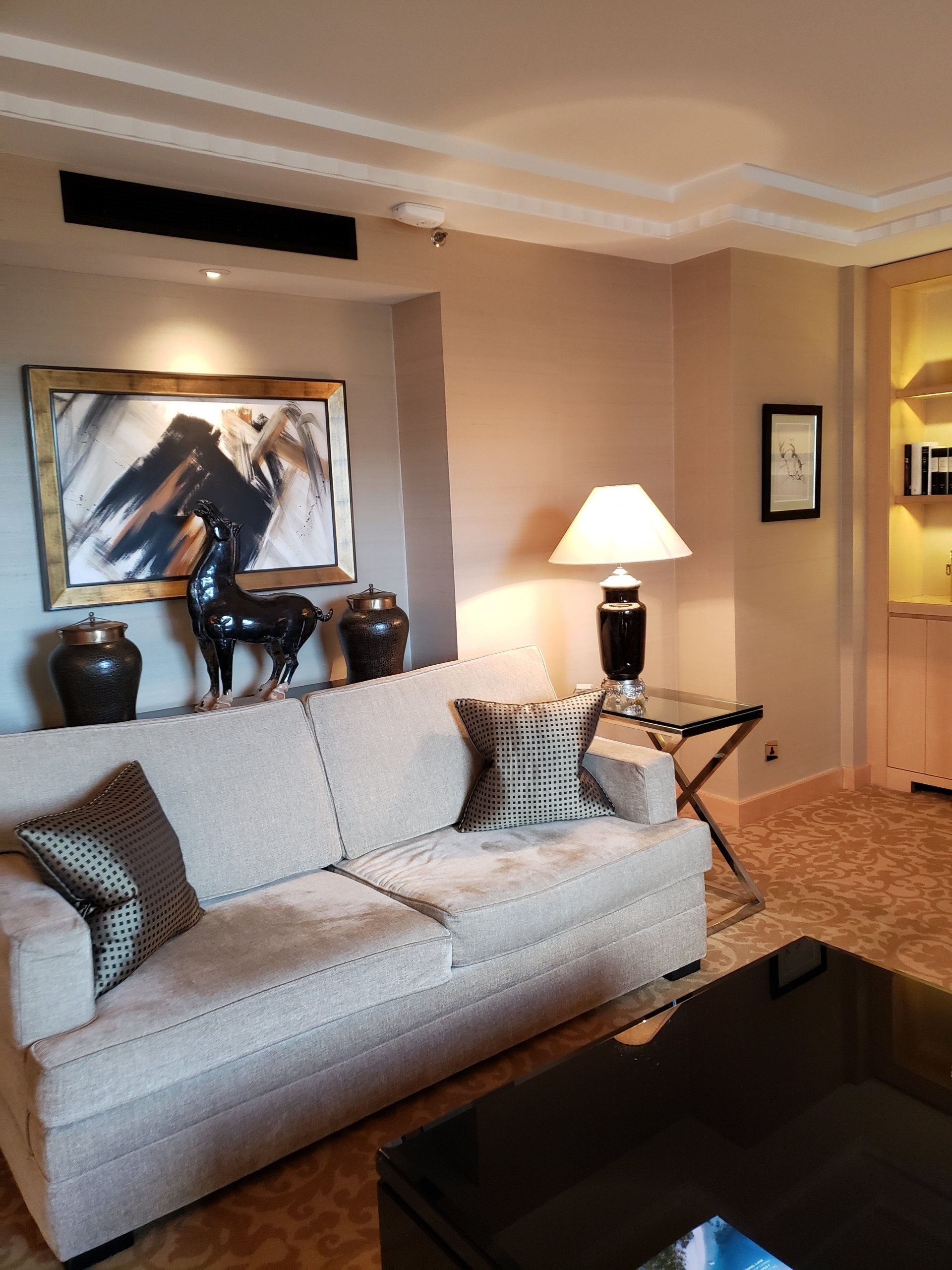 A living room with a couch and a lamp