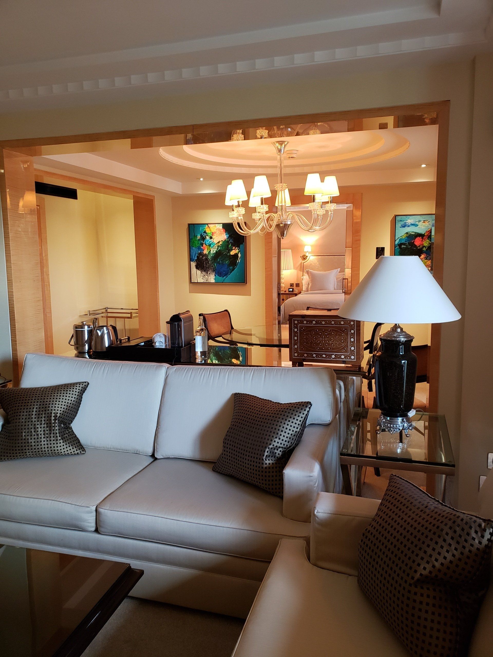 A living room with a white couch and a lamp