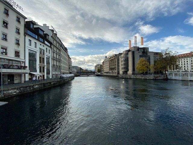 A river runs through a city between two buildings.