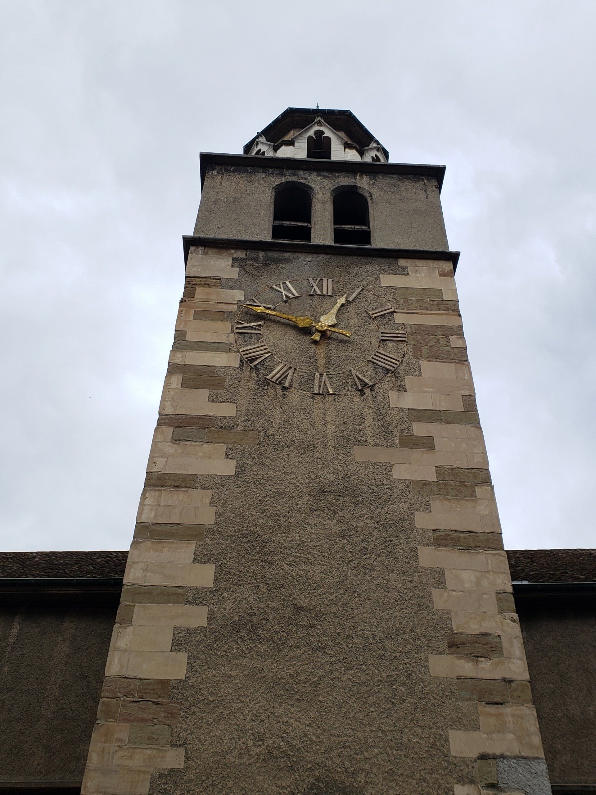 A clock on the side of a building shows the time as 4:20