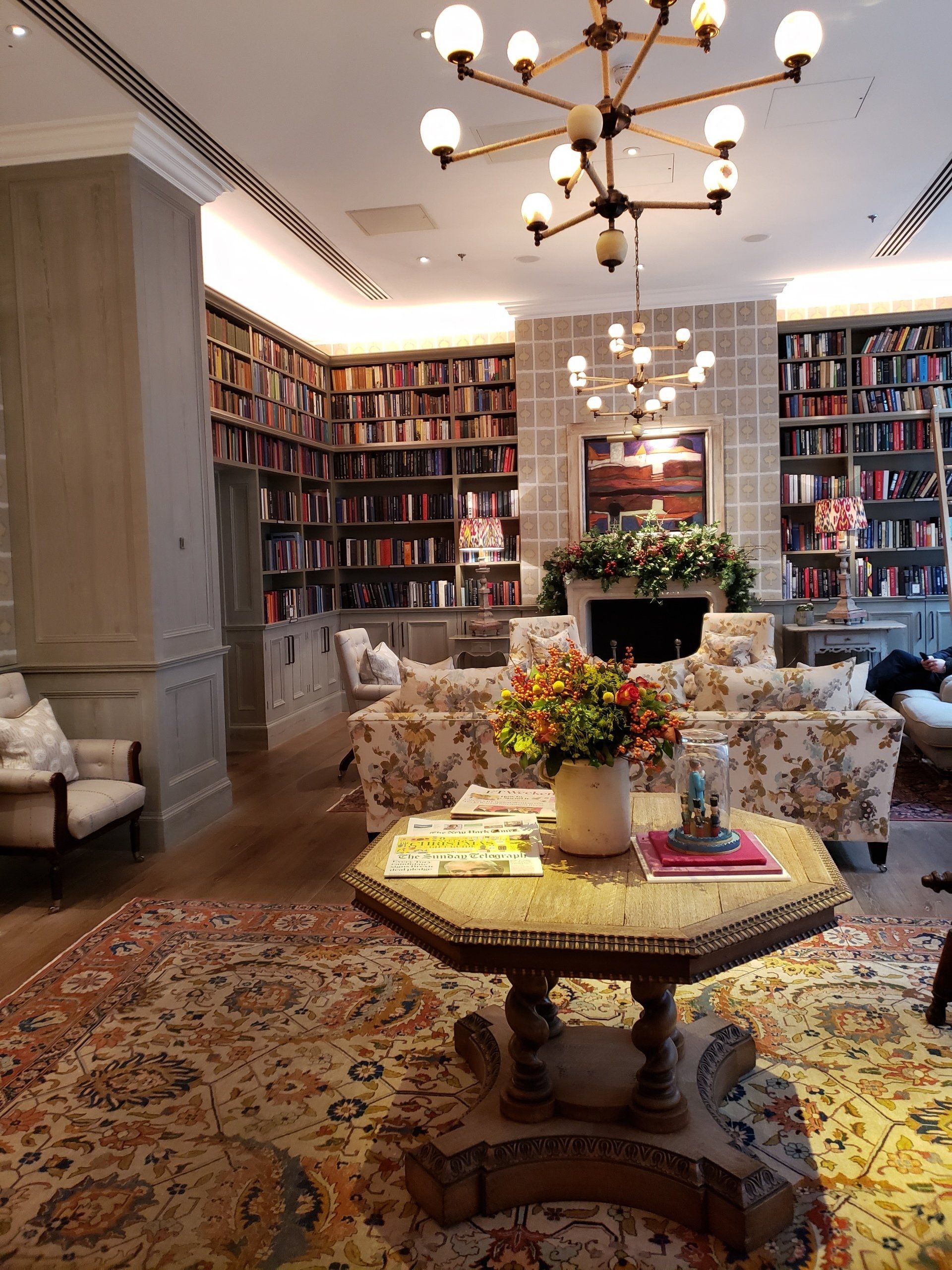 A living room filled with furniture and a table with flowers on it