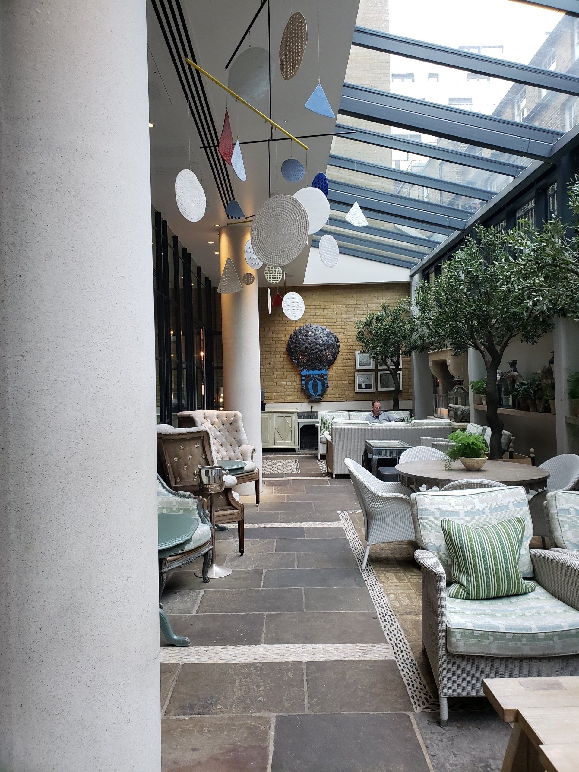 A room with a lot of furniture and a glass ceiling