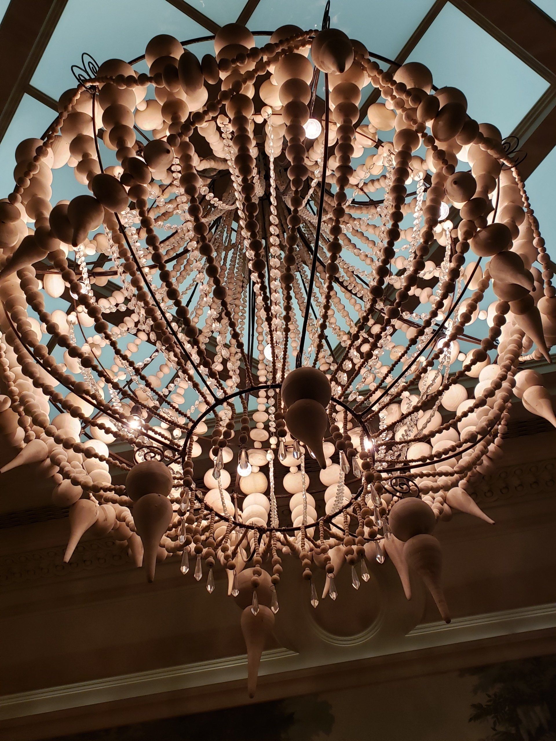 A large chandelier is hanging from the ceiling in a room