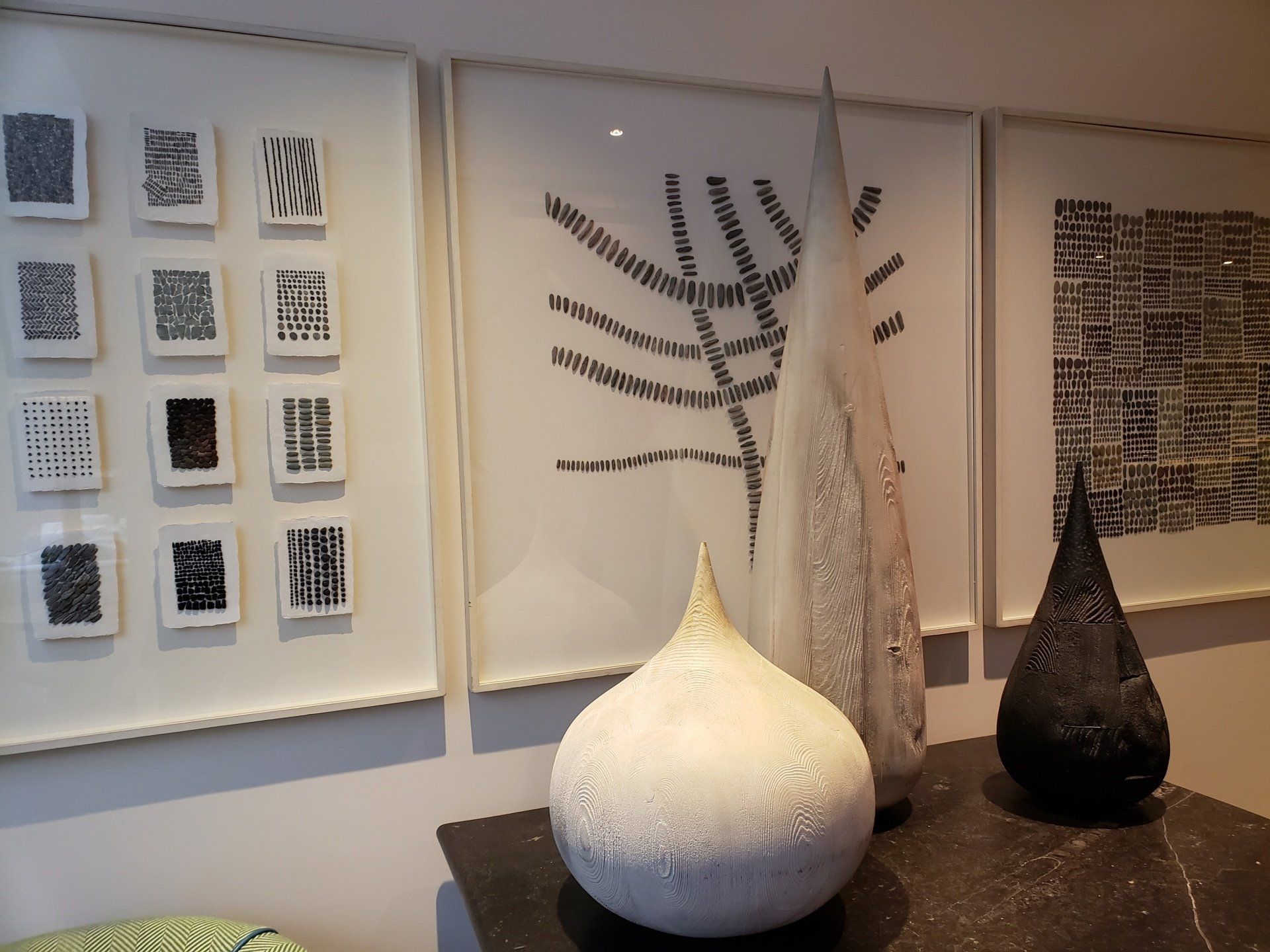 A display of paintings and a vase on a table