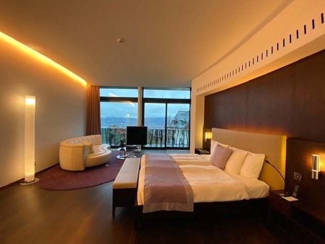 A hotel room with two beds and a couch