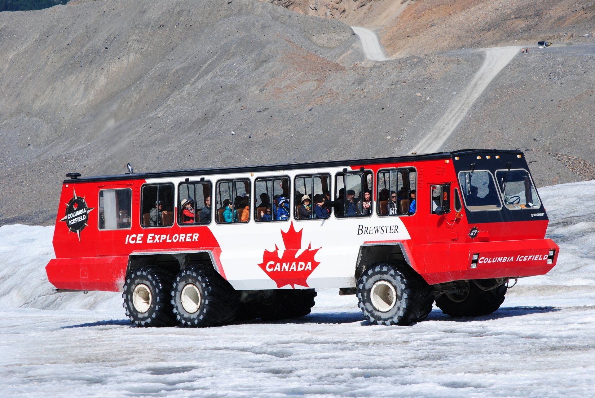 A red and white bus that says ice explorer on it