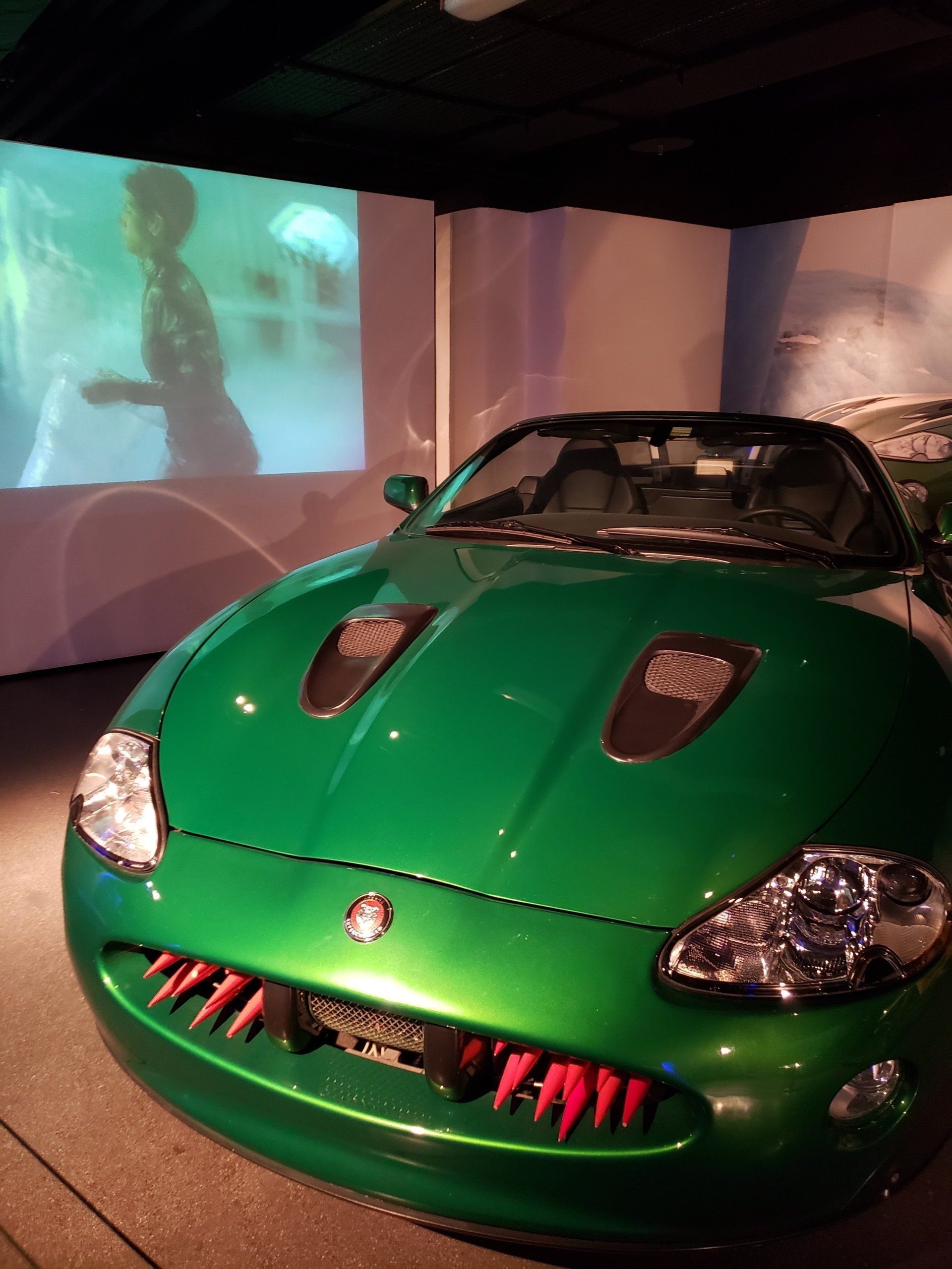 A green sports car with the word jaguar on the front