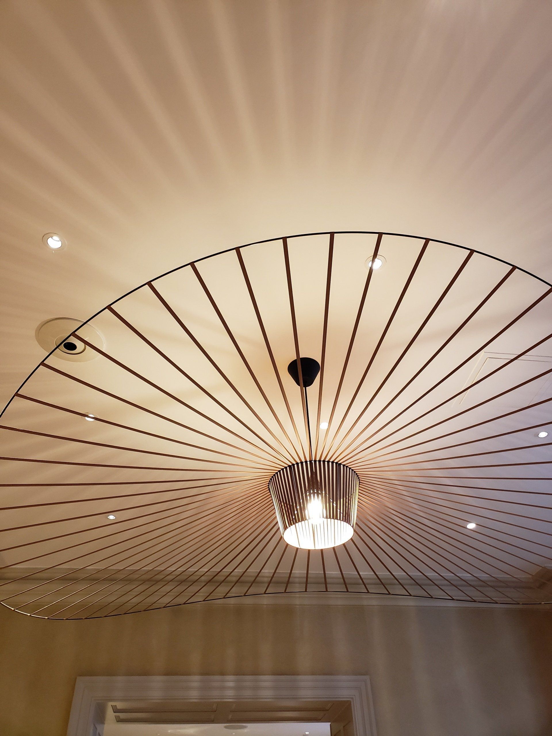 A light fixture is hanging from the ceiling in a room.