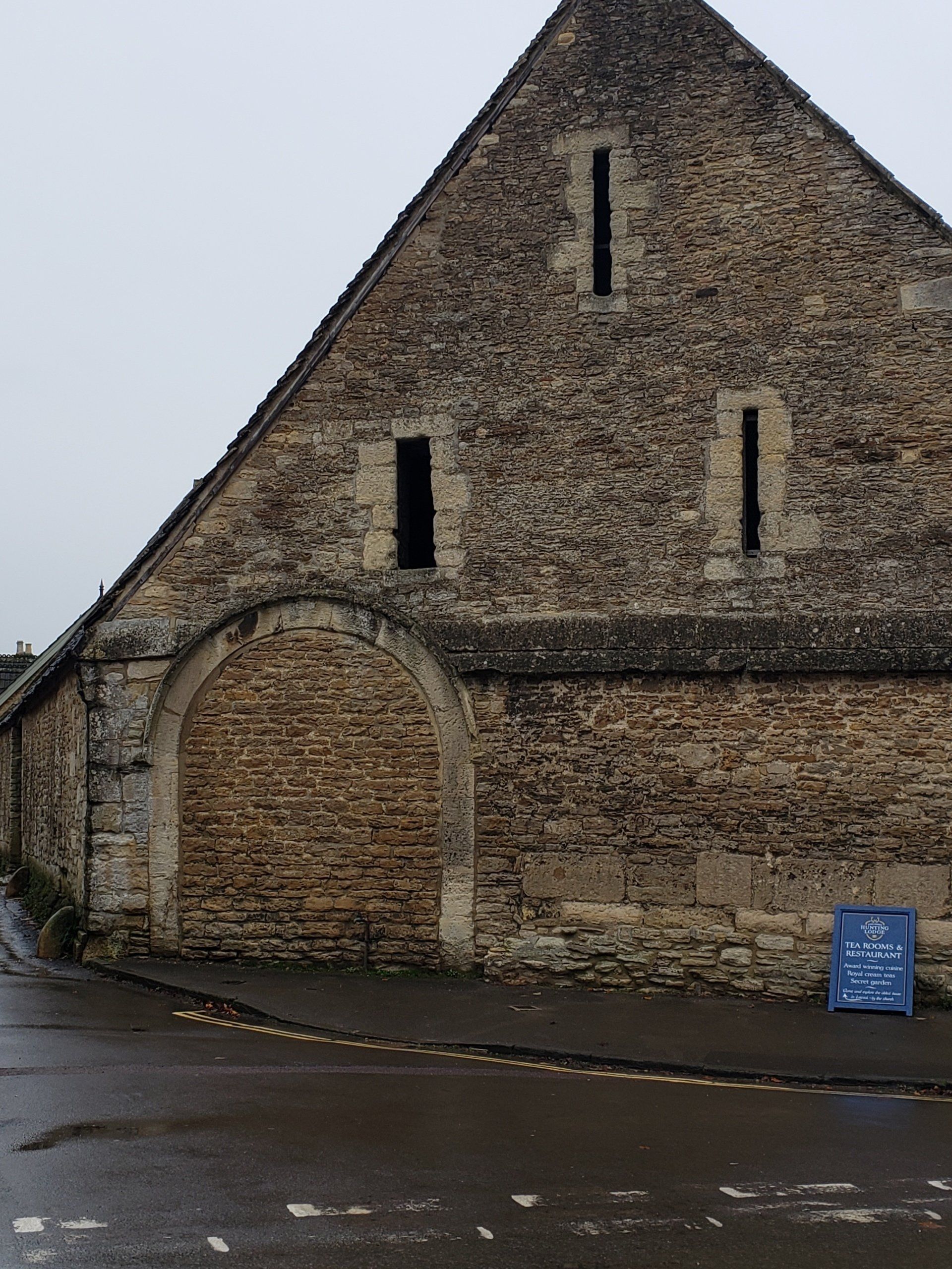 A brick building with a triangle shaped roof