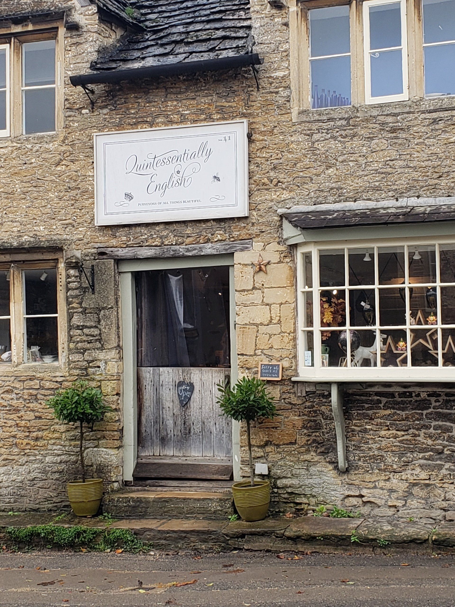 A stone building with a sign that says ' afternoon tea ' on it