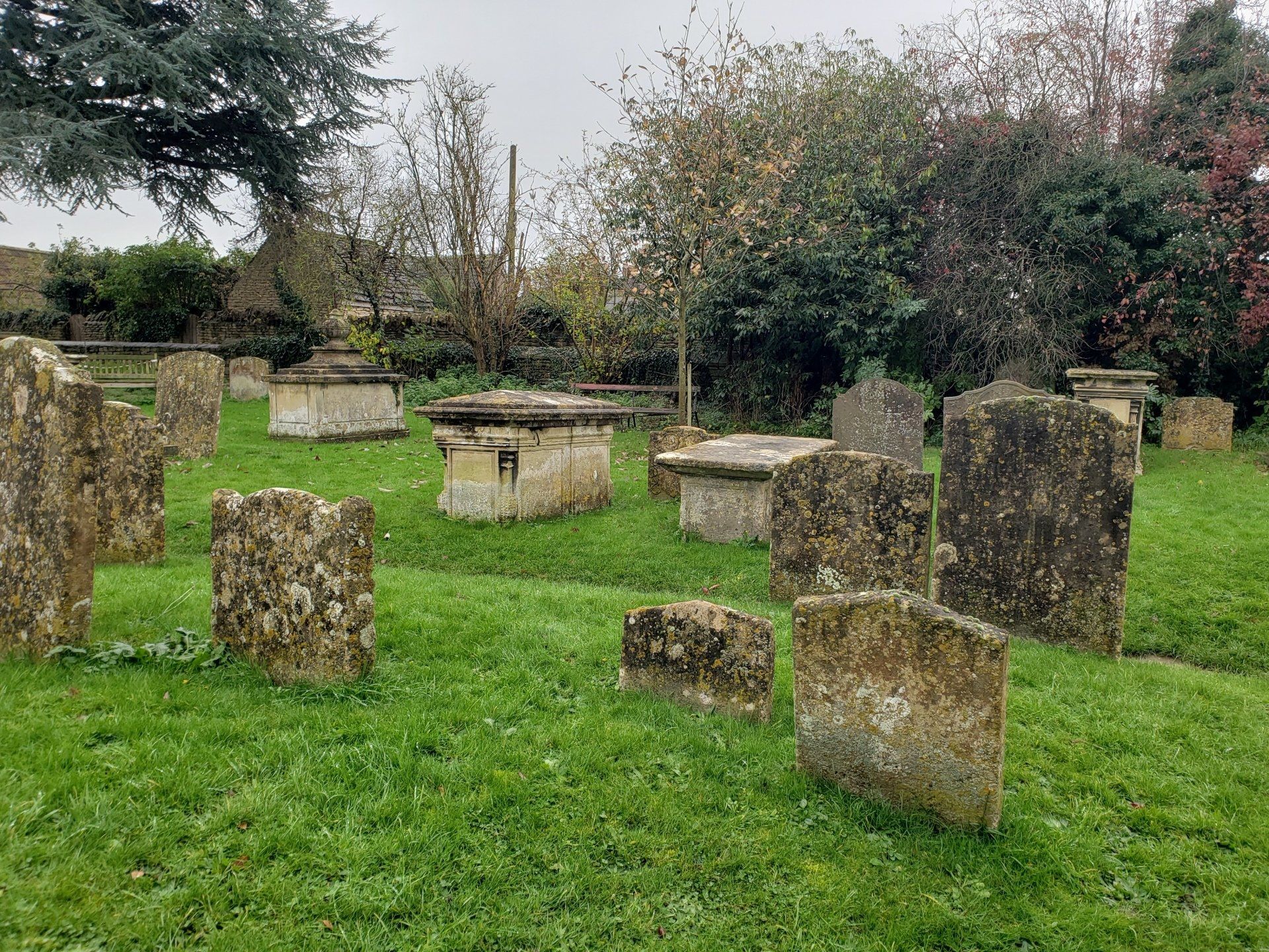 A cemetery with a lot of graves in the grass.