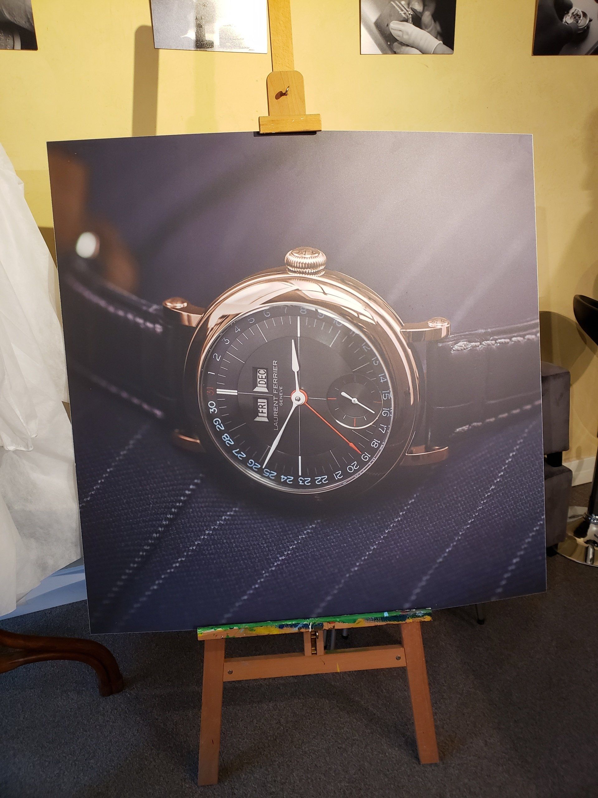 A painting of a watch on a wooden easel