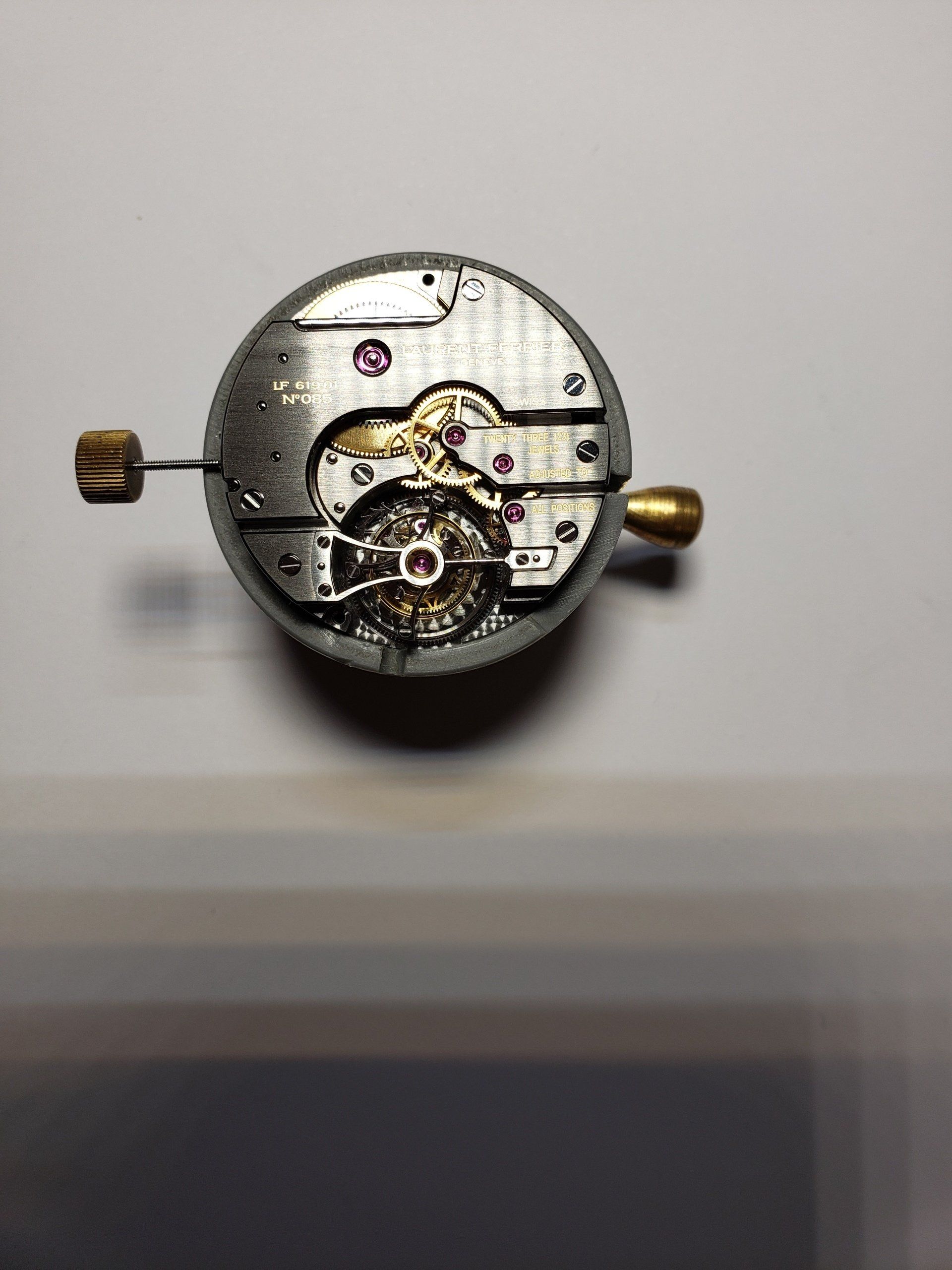 A close up of a watch mechanism on a white surface