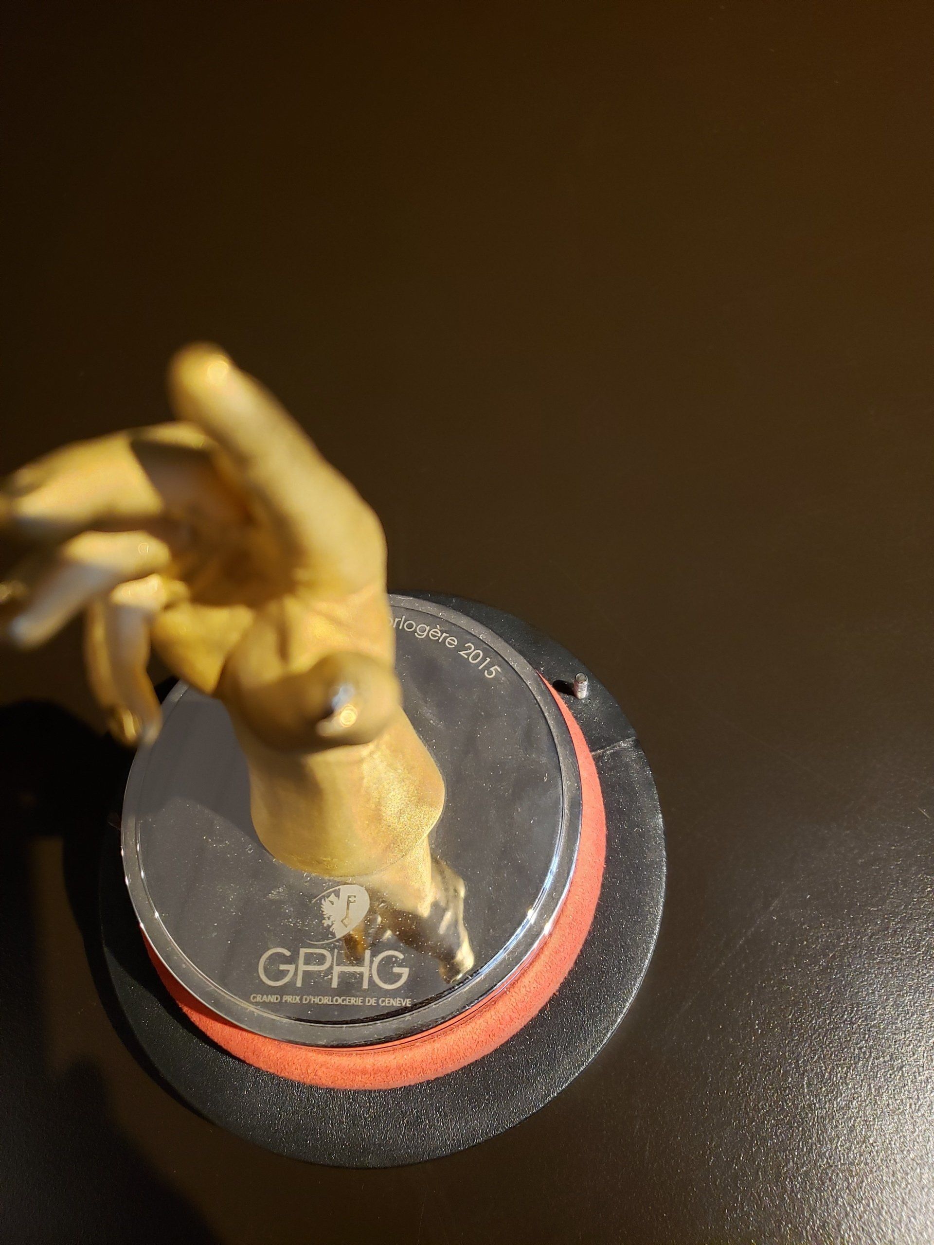 A statue of a hand is sitting on top of a gphg coin