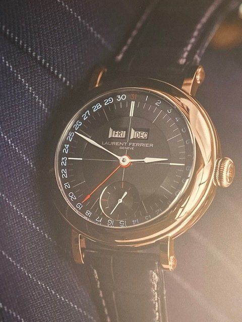 A close up of a watch with a black band