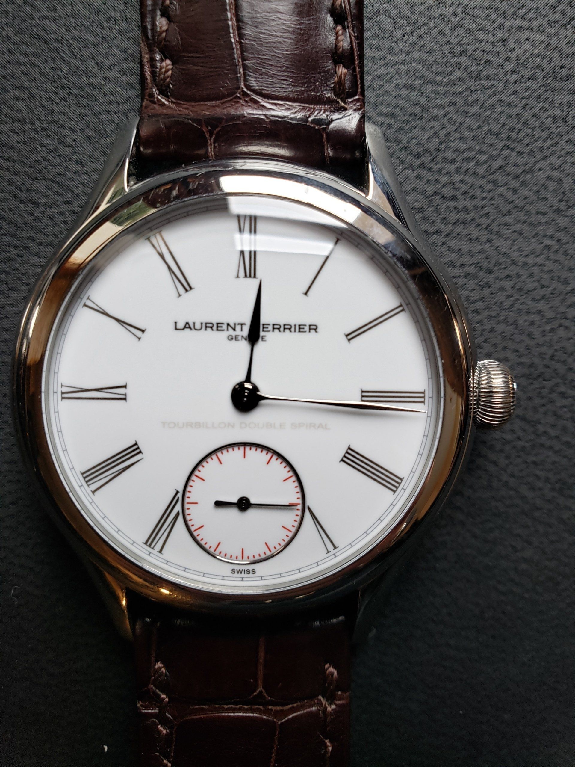 A laurent price watch with a brown leather band