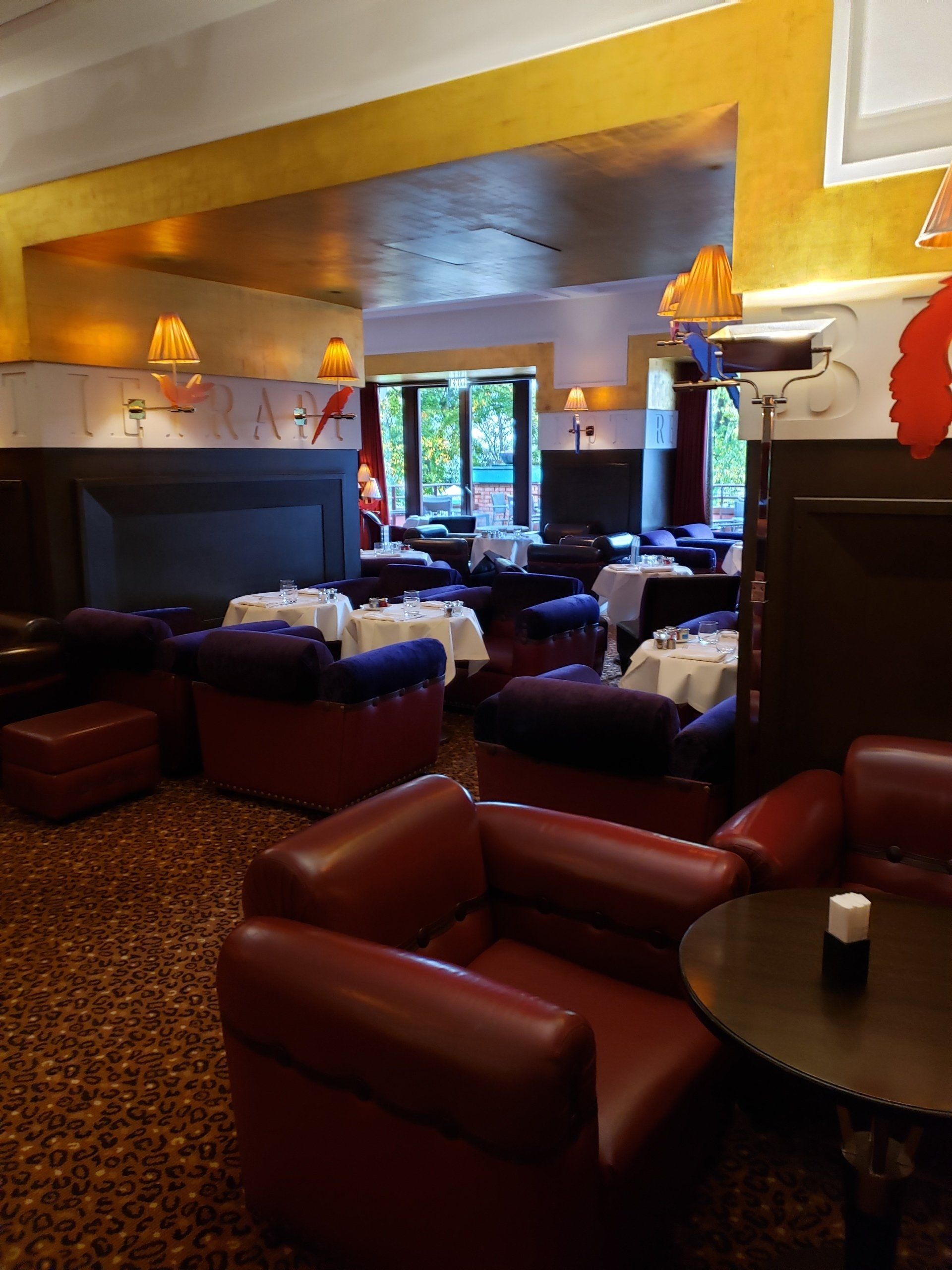 A restaurant with tables and chairs and a fireplace