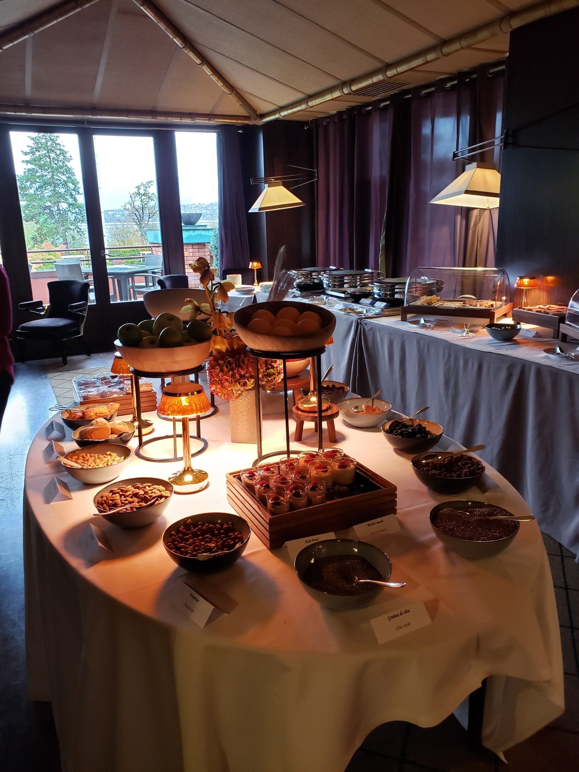 A buffet table with bowls of food on it