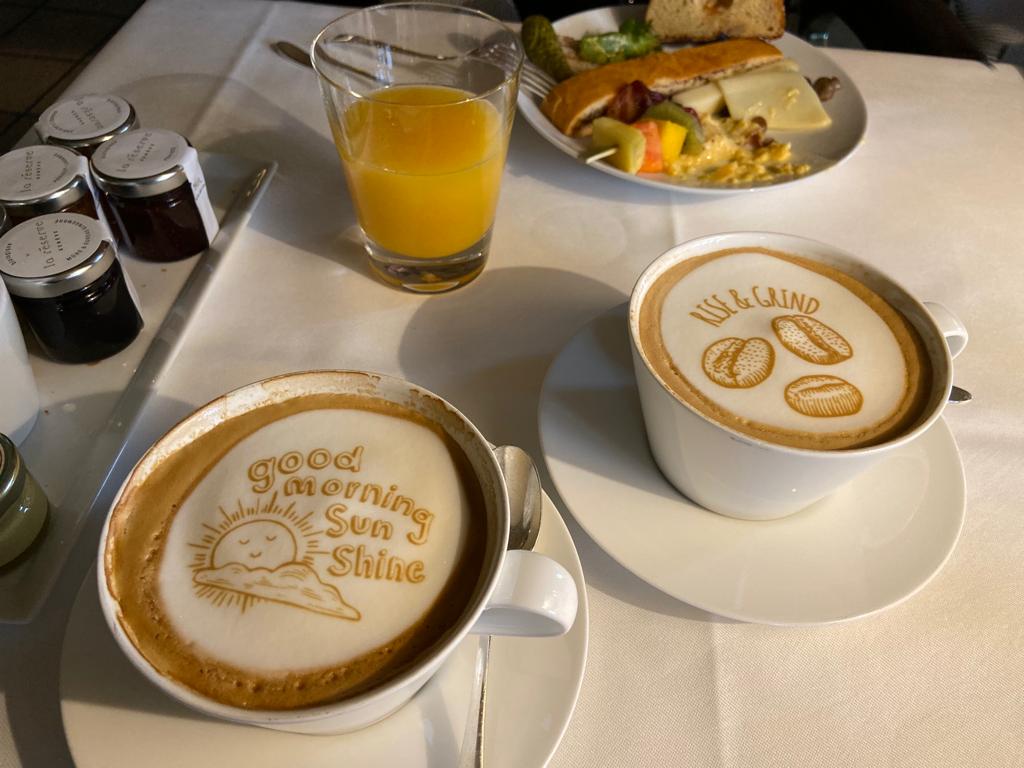 Two cups of coffee with the words good morning sea shine on them