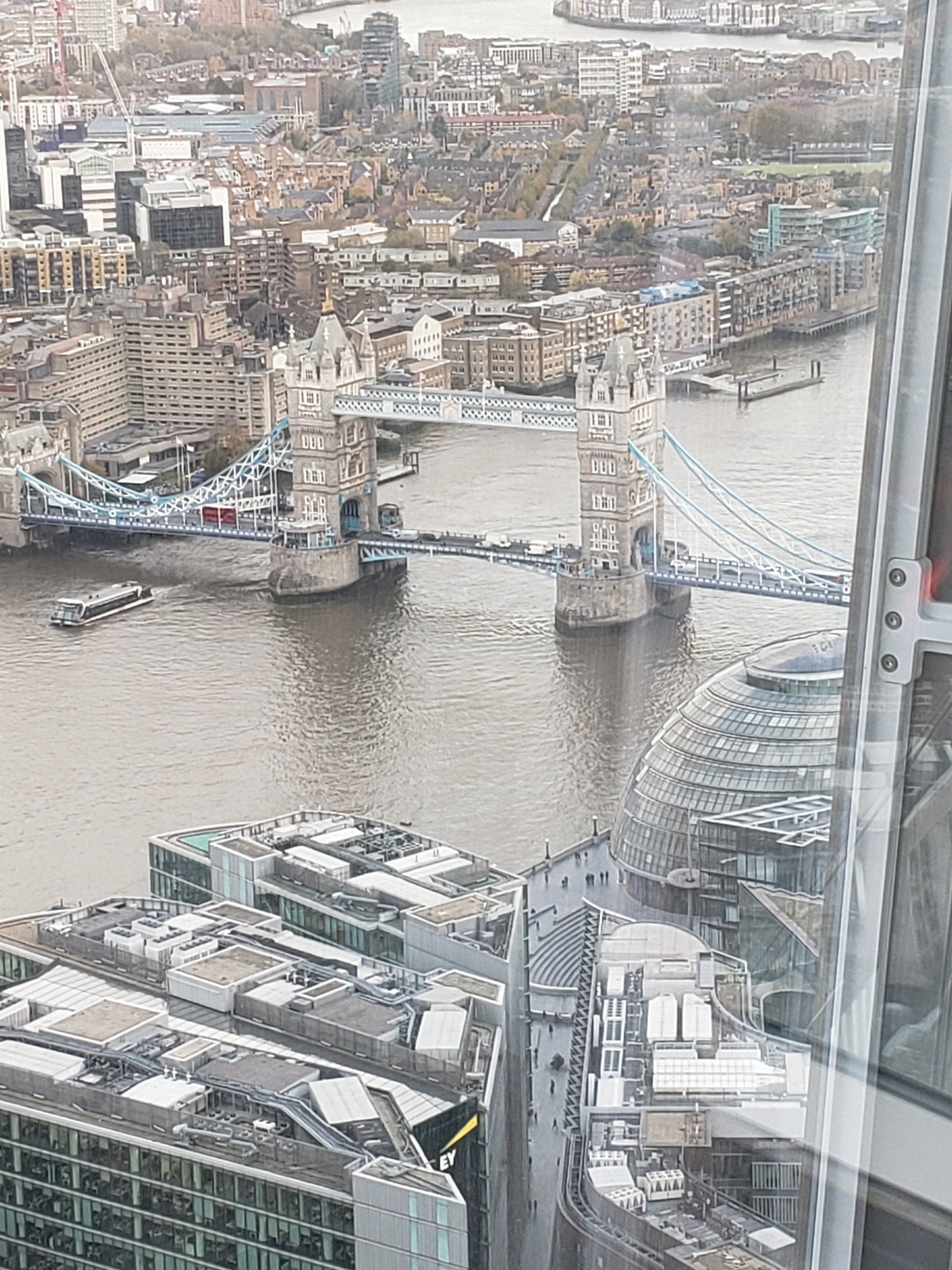 An aerial view of a city with a bridge over a body of water.